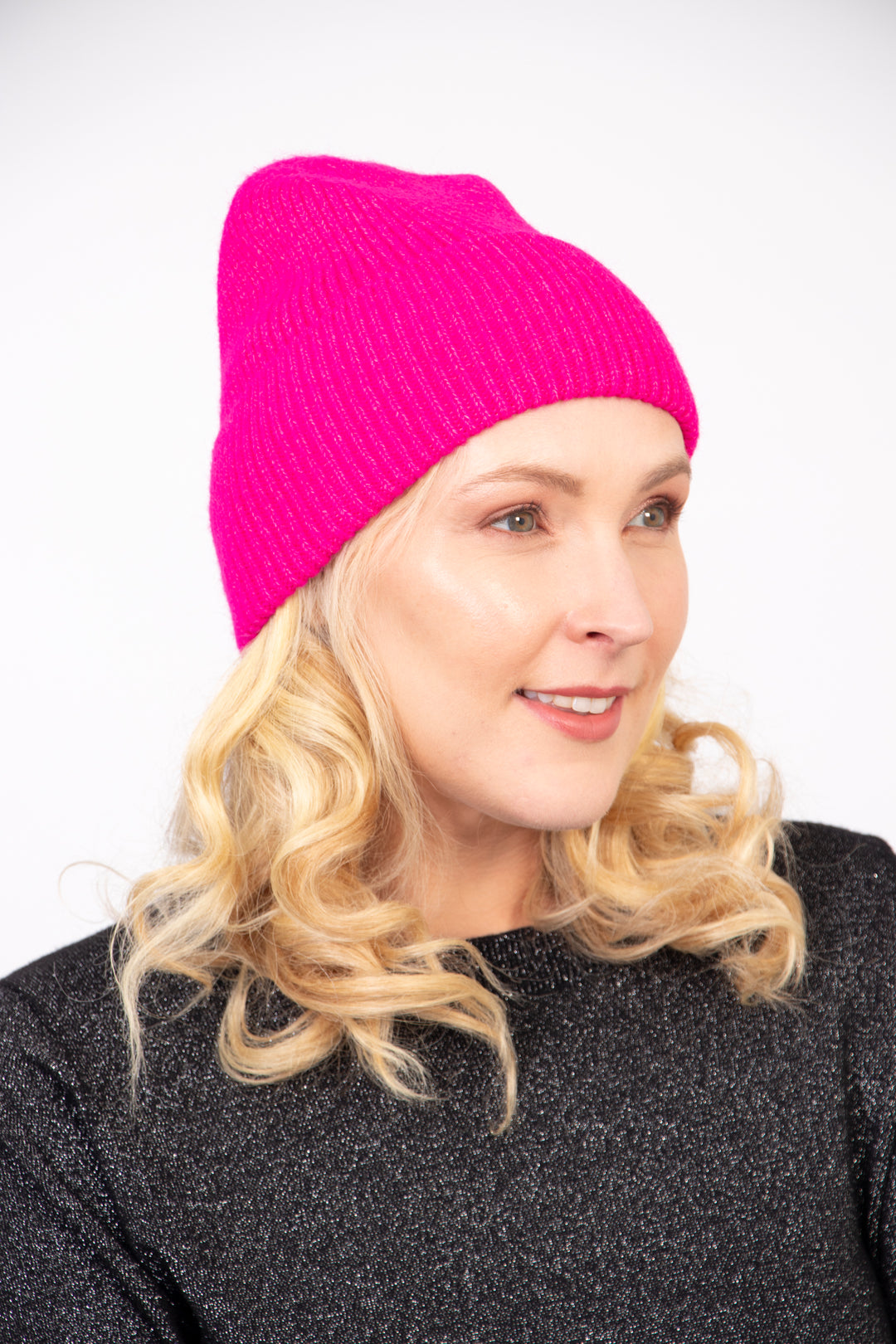 model wearing a fuchsia pink winter beanie hat