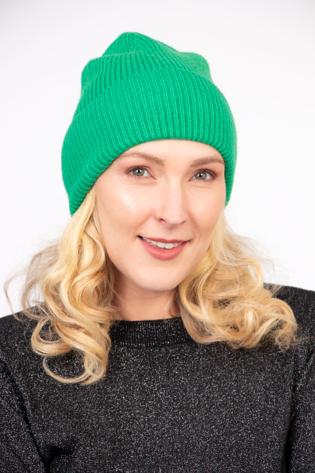 model wearing a bright green winter beanie hat