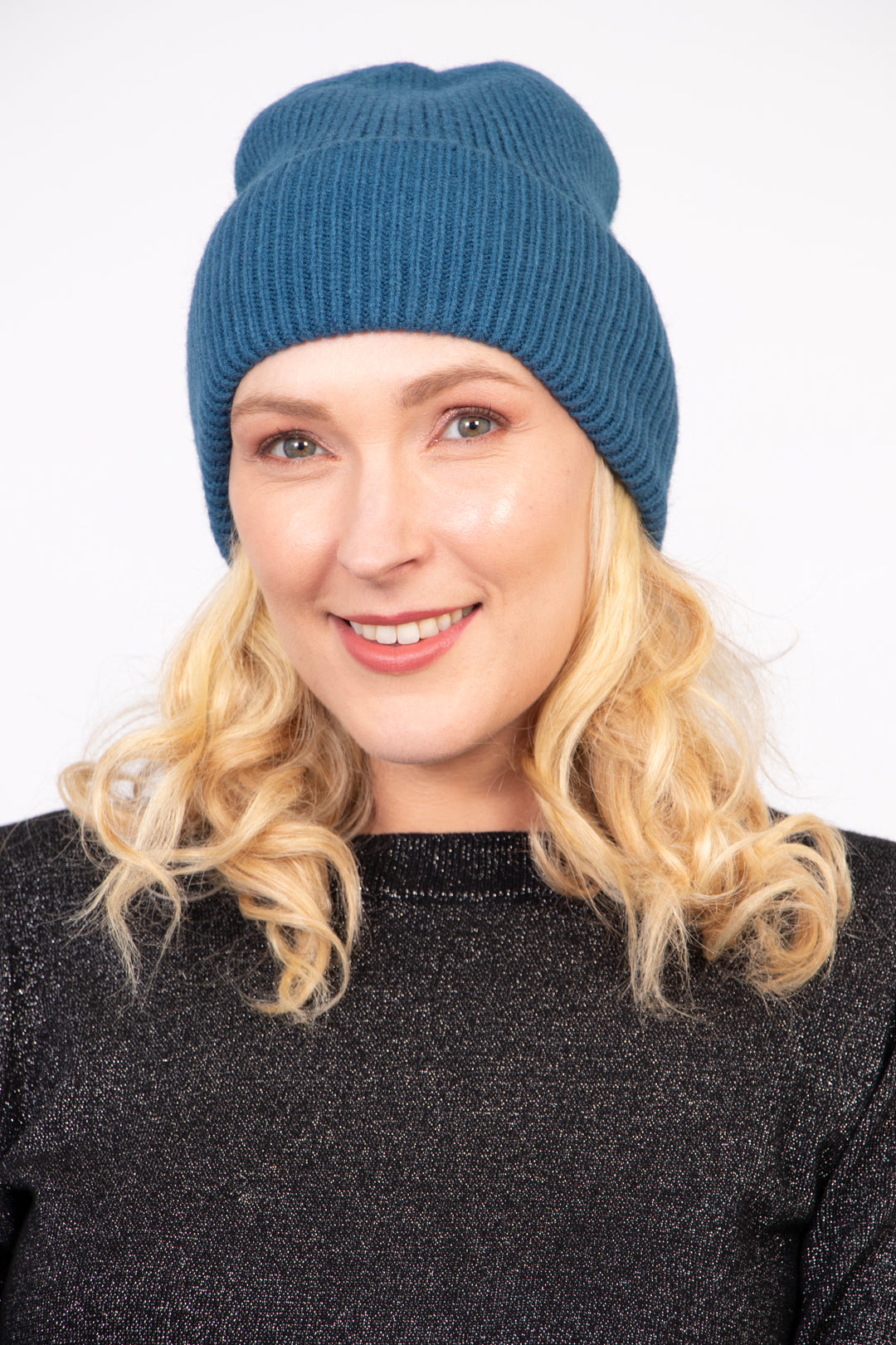 model wearing a teal blue winter beanie hat