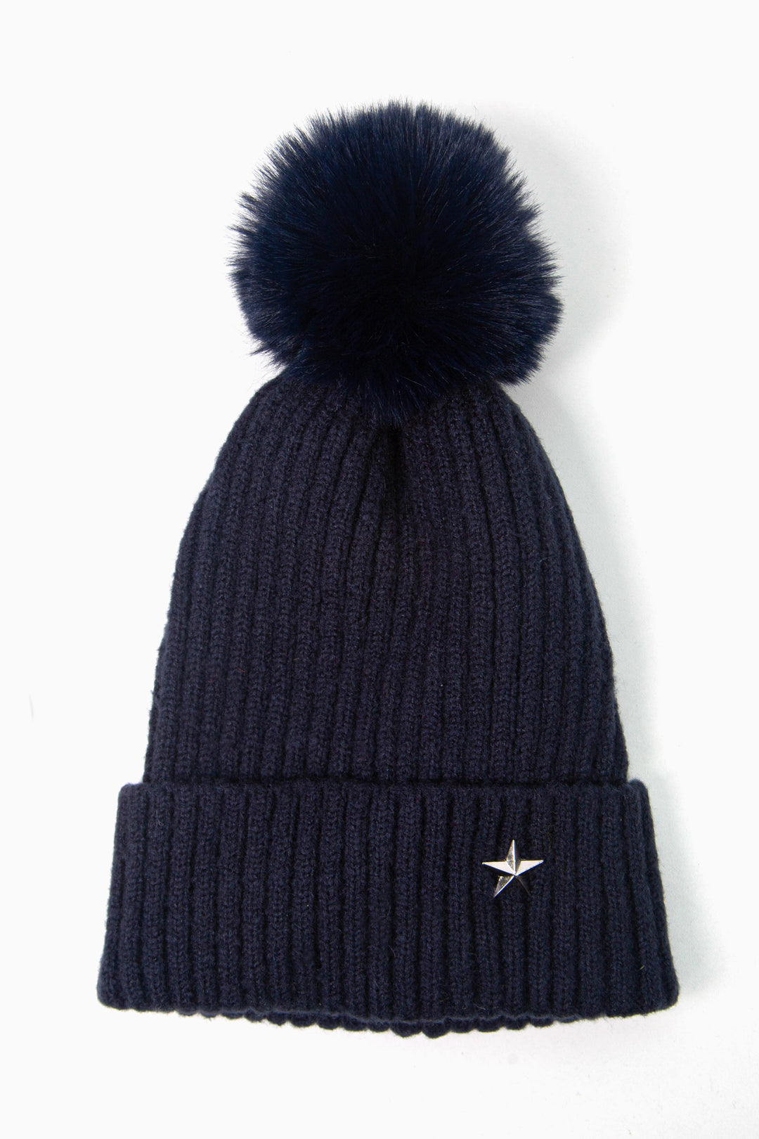 navy blue ribbed beanie hat with a pom pom on top and a silver coloured metal star motif on the cuff of the hat