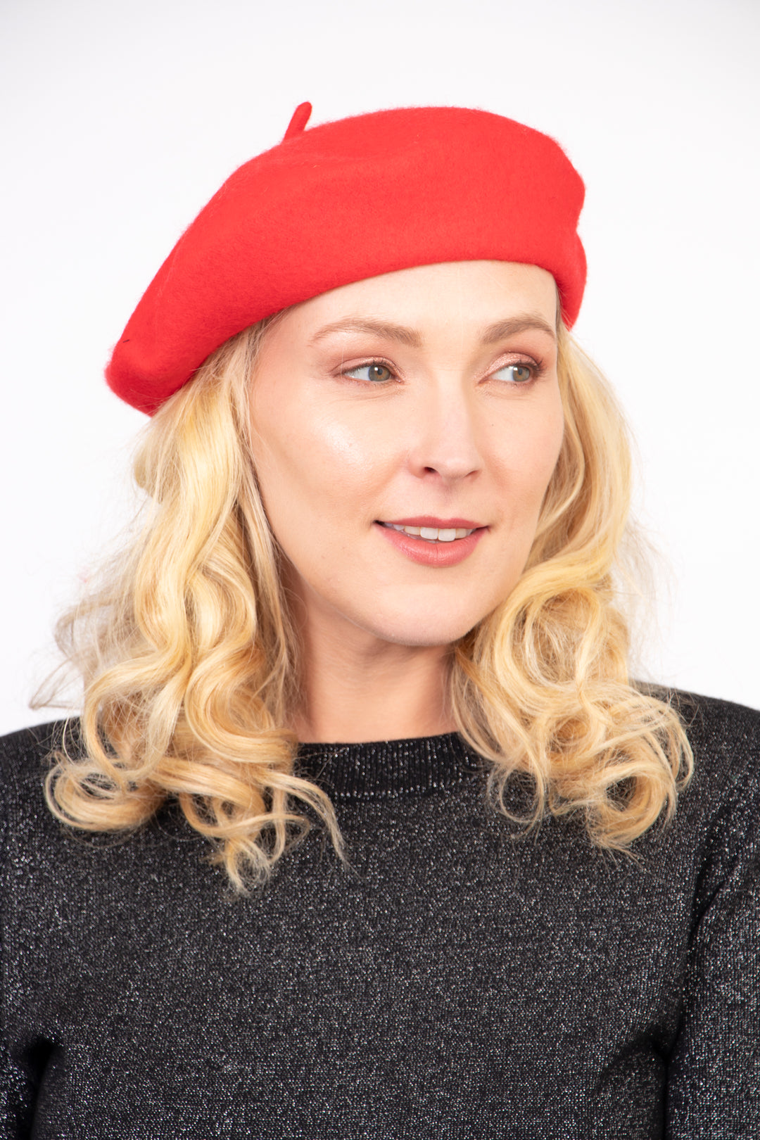 model wearing a bright red plain beret hat