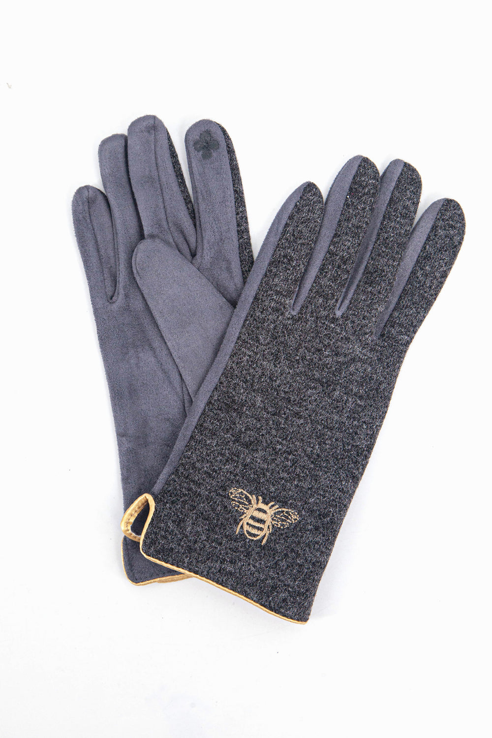 a close up of the grey winter gloves showing up close the gold embroidered bee on the back of the wrist and the gold trim around the cuffs.