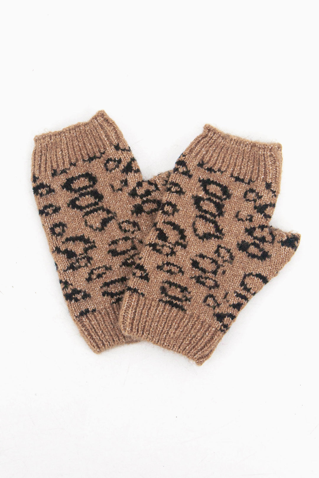 neutral leopard print wrist warmers laying flat, they have ribbed cuffs at each end and a neutral, brown and black leopard print pattern