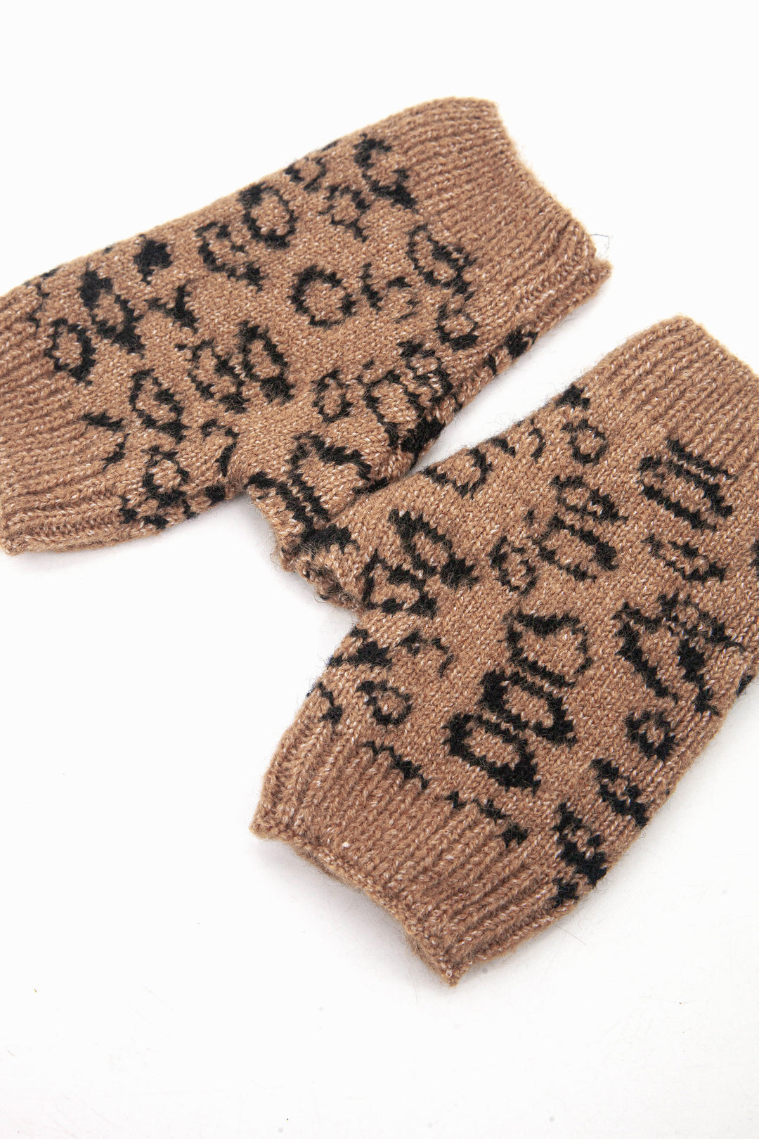 neutral leopard print wrist warmers with thumb holes, showing the opening at each end 