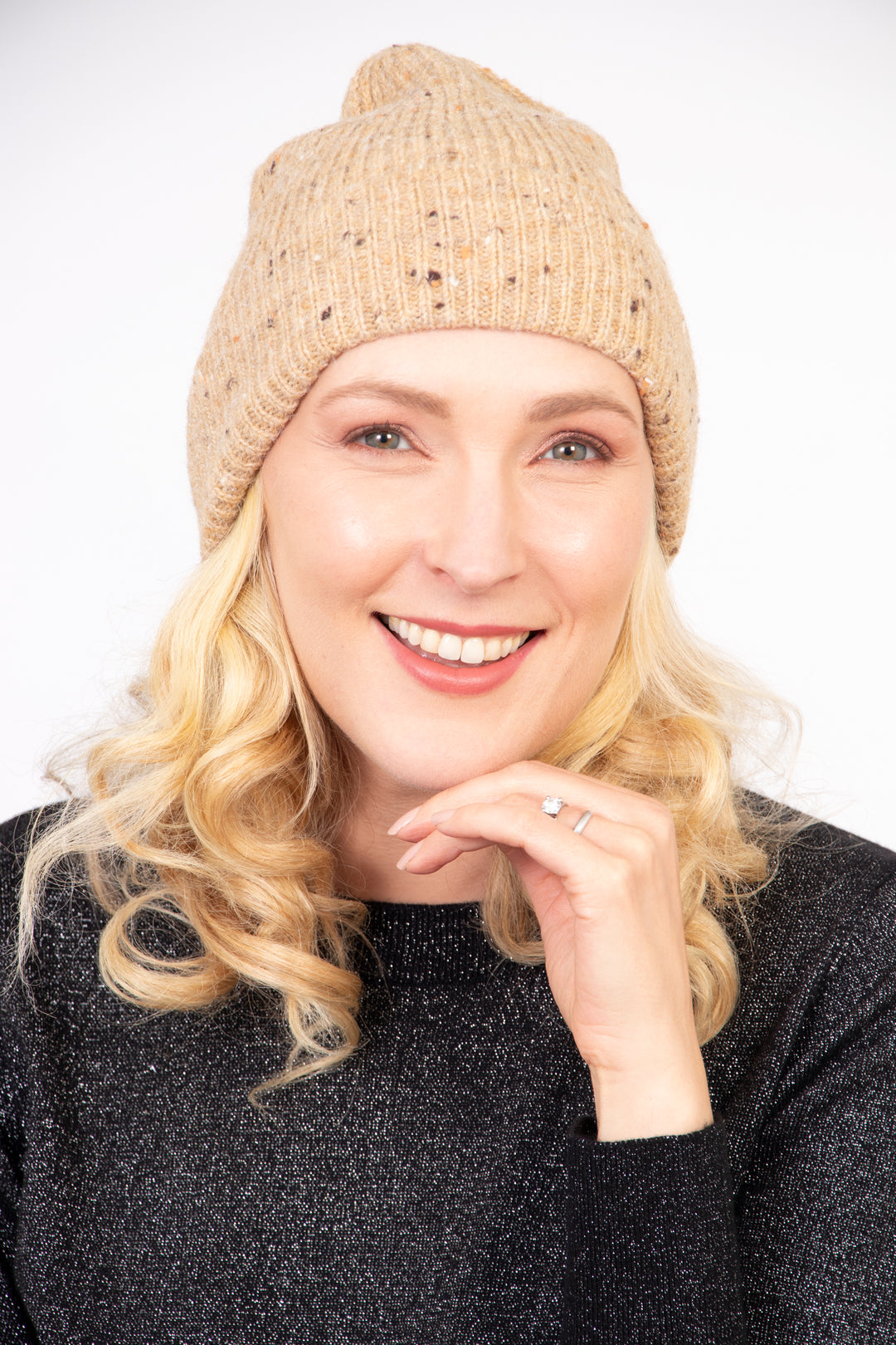 model wearing a light brown marl knit beanie hat