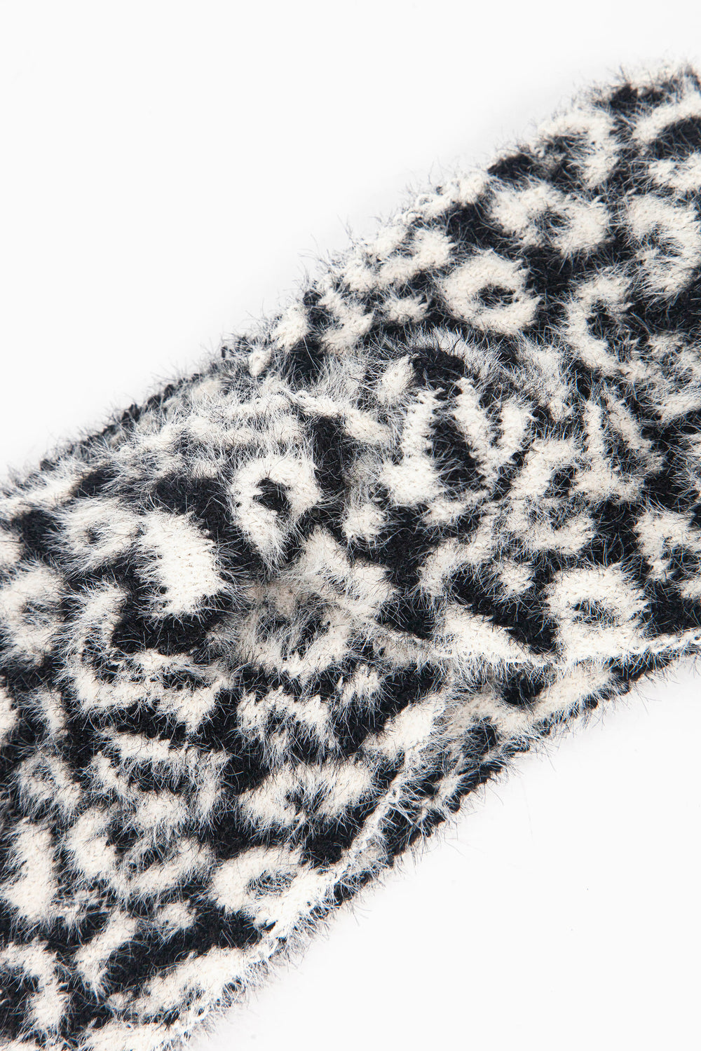 close up of the fluffy material of the black and white animal print headband