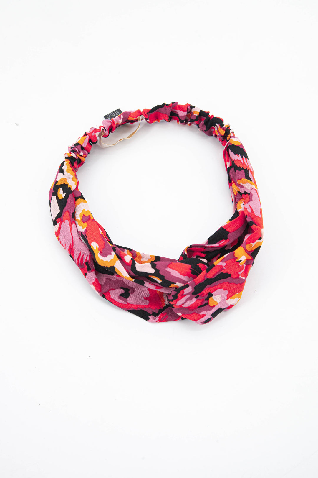 black and pink abstract print fabric headband with a twist front