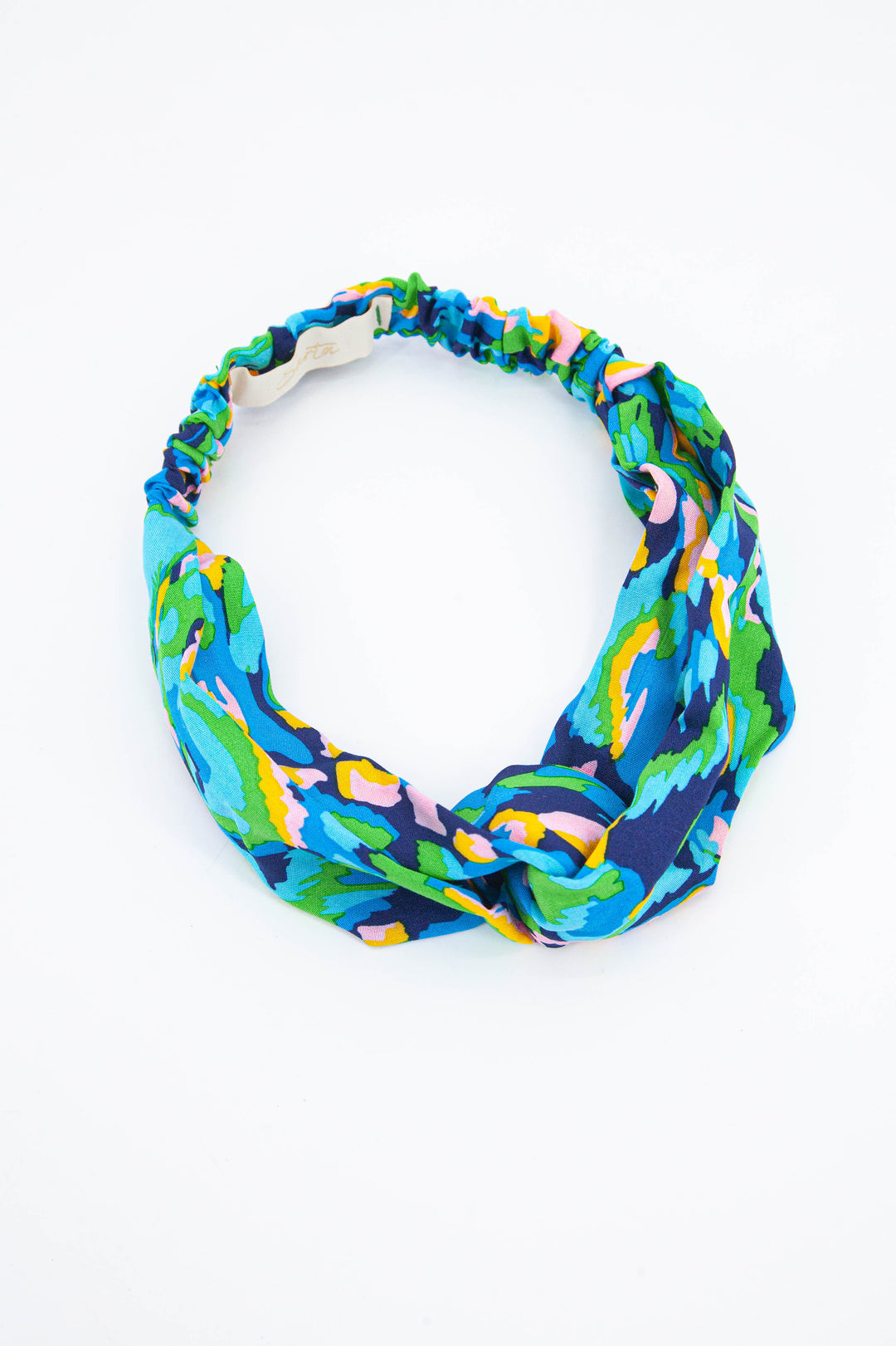 green, blue and yellow abstract print elasticated headband with a twist front