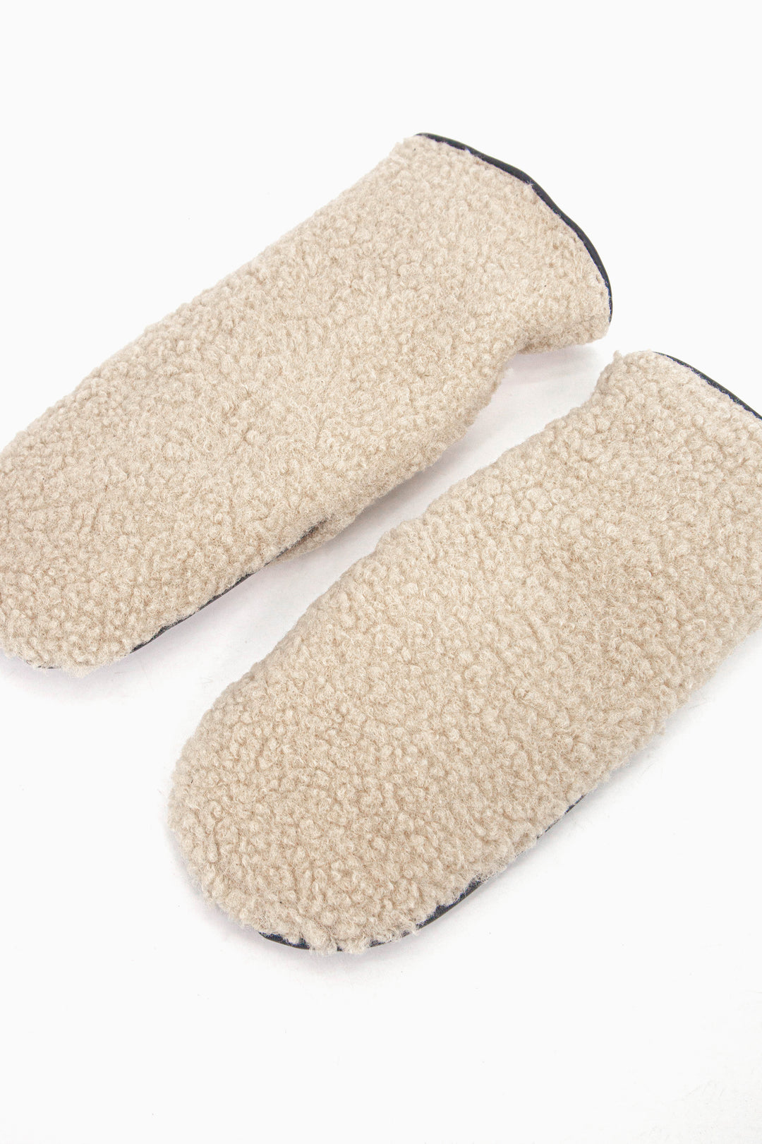 showing the mitts laying flat, the cream borg fleece is shown to cover the entire back of the gloves.