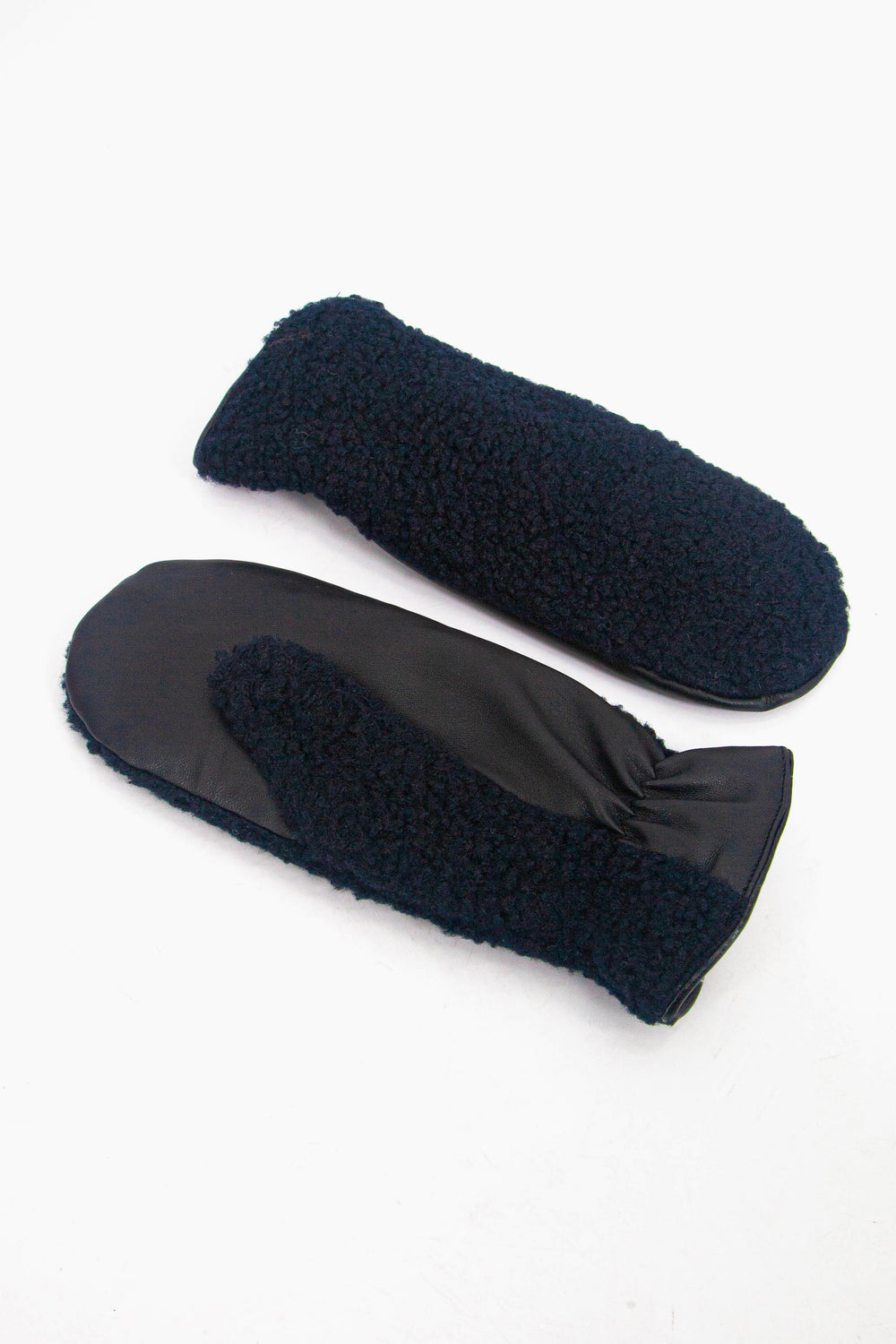 showing the fleece mittens laying flat, one is palm up the other palm down. the fleece is only on the back of the glove, the palm is made from polyester.