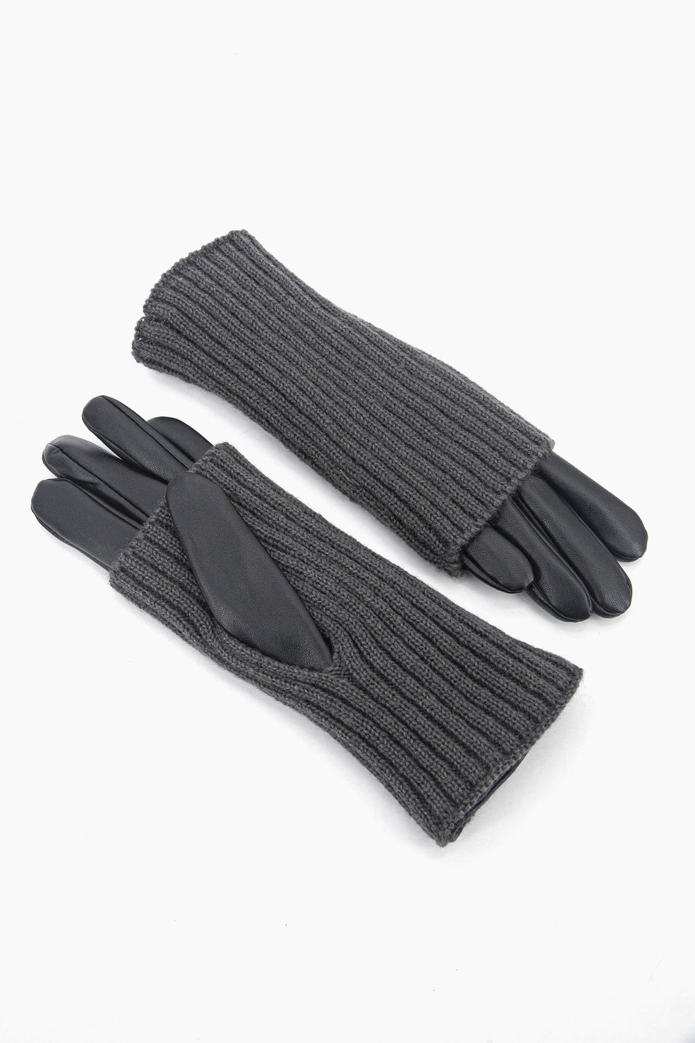 showing the gloves with one palm up and the other palm down. the knitted overlay is shown to cover the gloves from the cuff to mid way on the palm. there is a thumb hole in the overlay which the thumb of the PU glove goes through. 