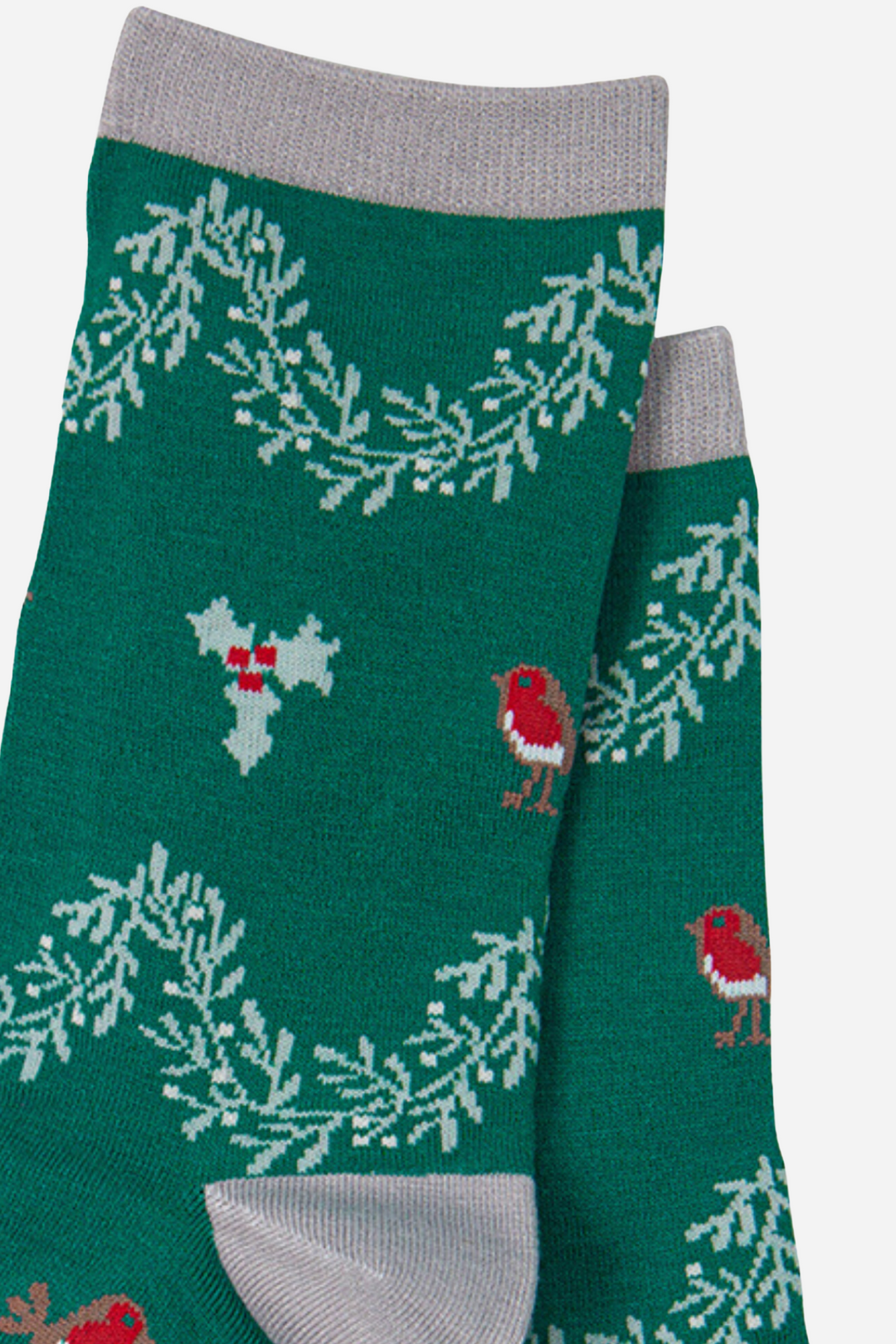 close up of the red robin and green holly design on the green  bamboo socks