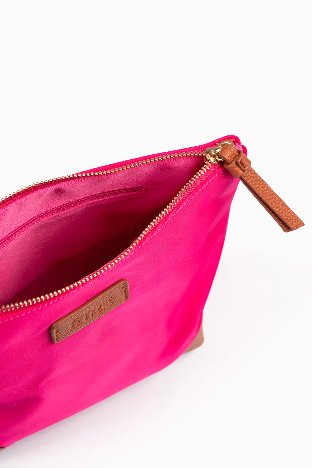 showing the top of the bag with the zip compartment open, there is a small internal zip pocket visible