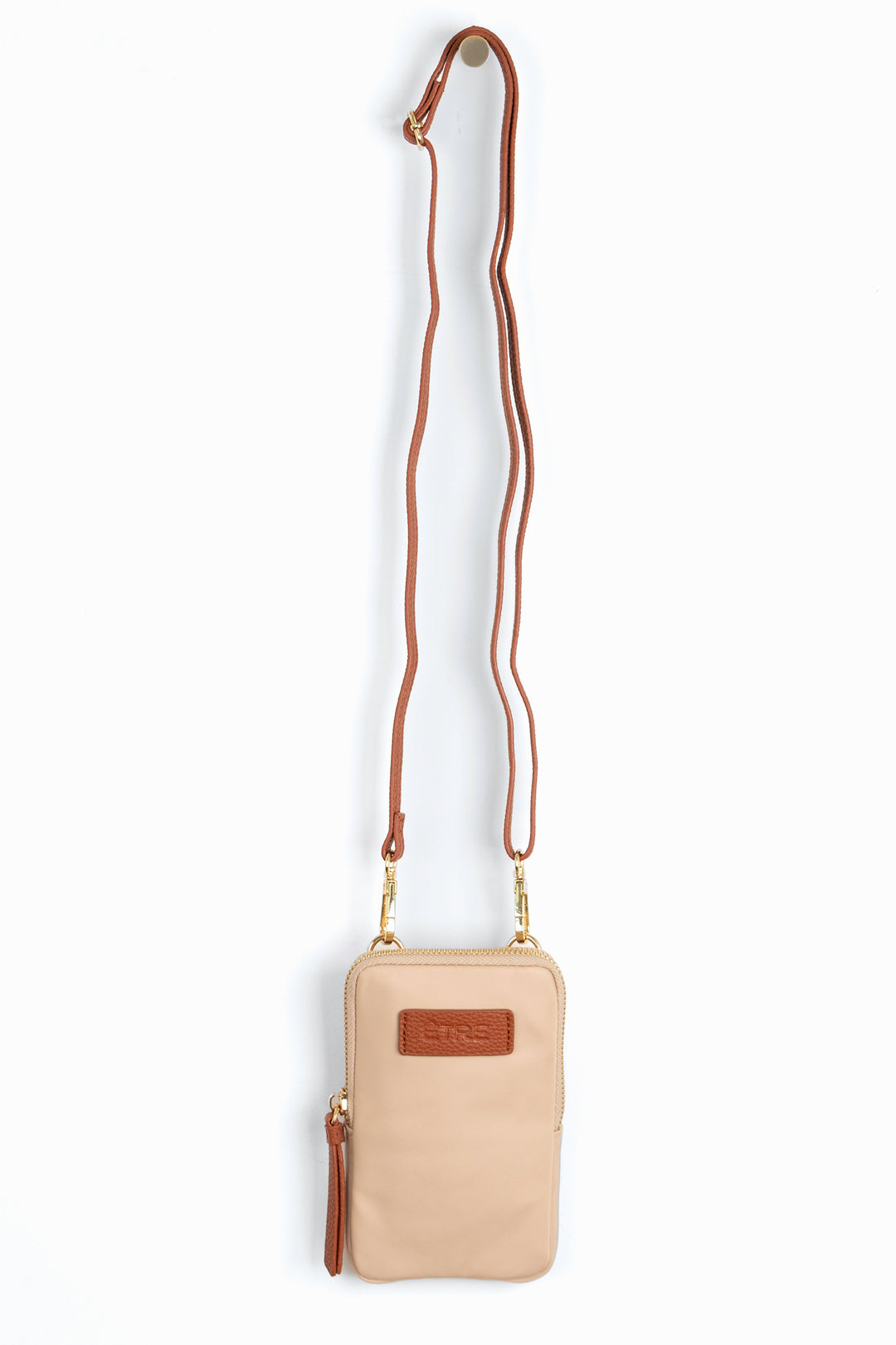 cream crossbody phone bag with tan accents and a tan removable adjustable crossbody strap