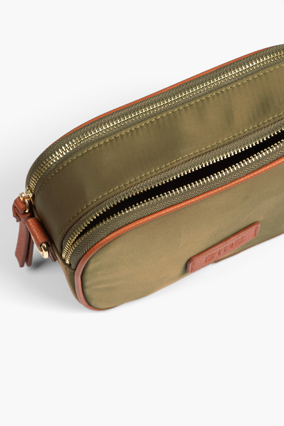 showing the bag from above, one of the compartments is zipped closed, the other is open showing two separate compartments within the design