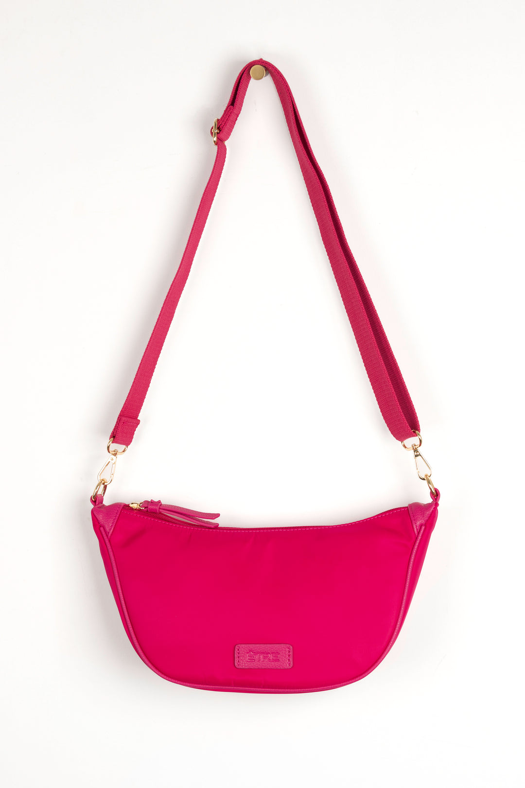 fuchsia pink nylon crossbody half moon sling bag with detachable bag strap