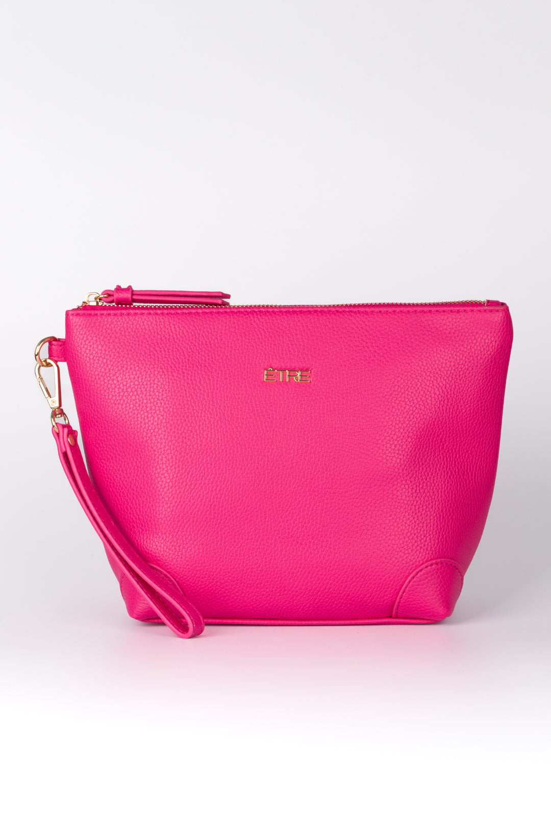  fuchsia pink faux leather vanity bag with a detachable wrist strap and top zip closure