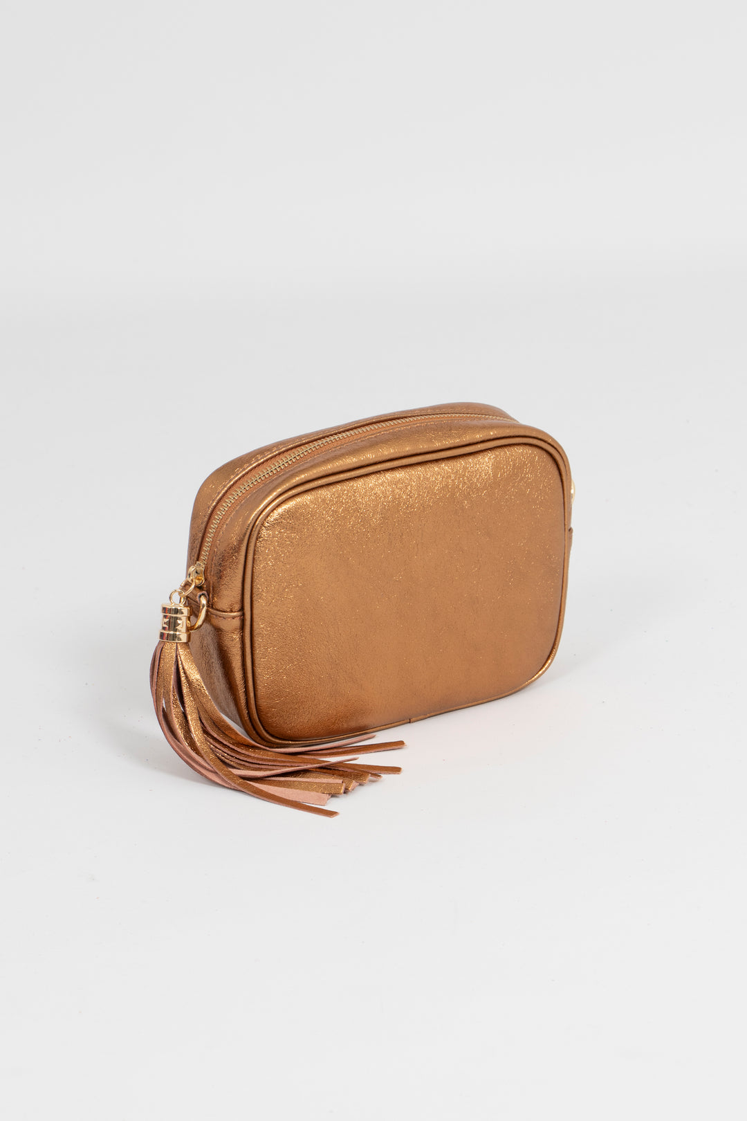 close up of the metallic bronze camera bag, showing the zip closuring compartment