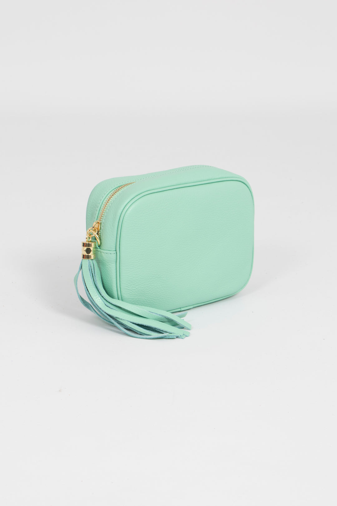 Close up showing zip closure of the mint green pebbled leather crossbody camera bag