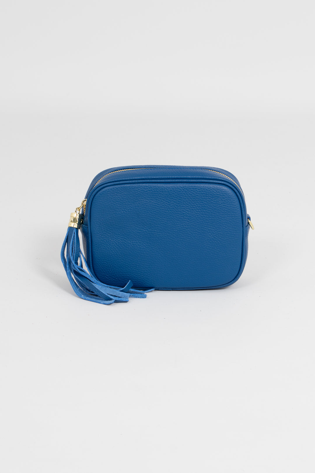 blue crossbody camera bag with a detachable adjustable clip on bag strap, gold hardware and decorative tassel