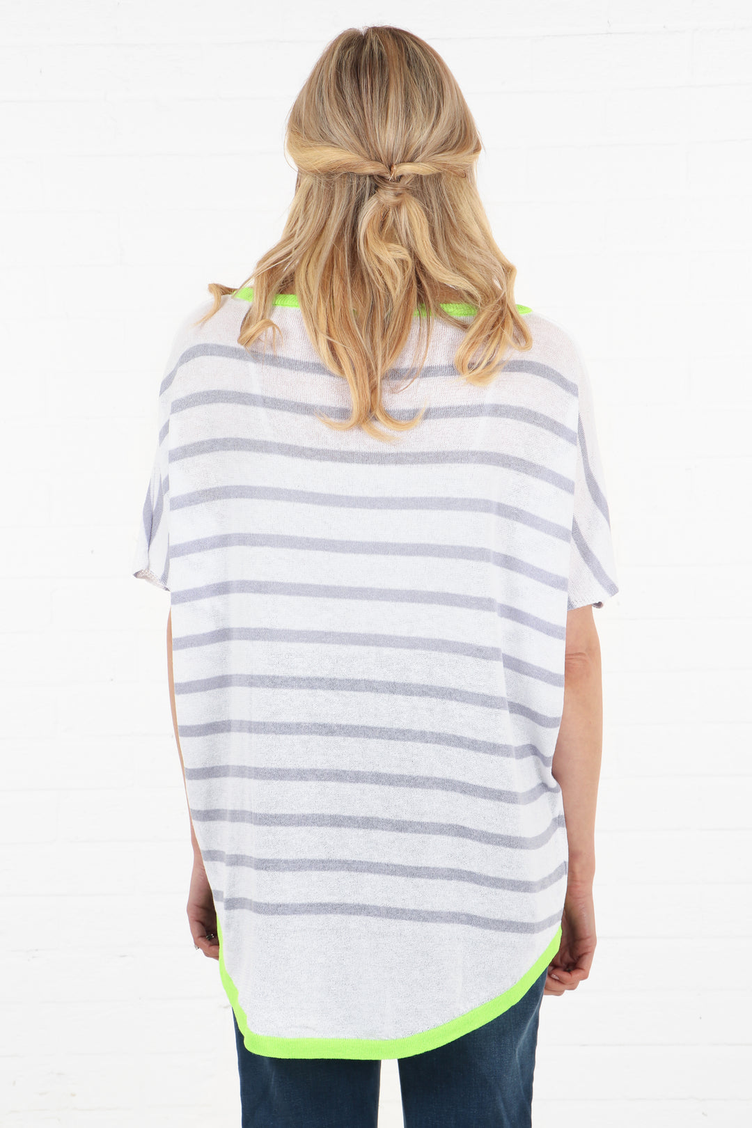 model showing the back of the striped cotton jumper showing that the stipe pattern is all over the garment