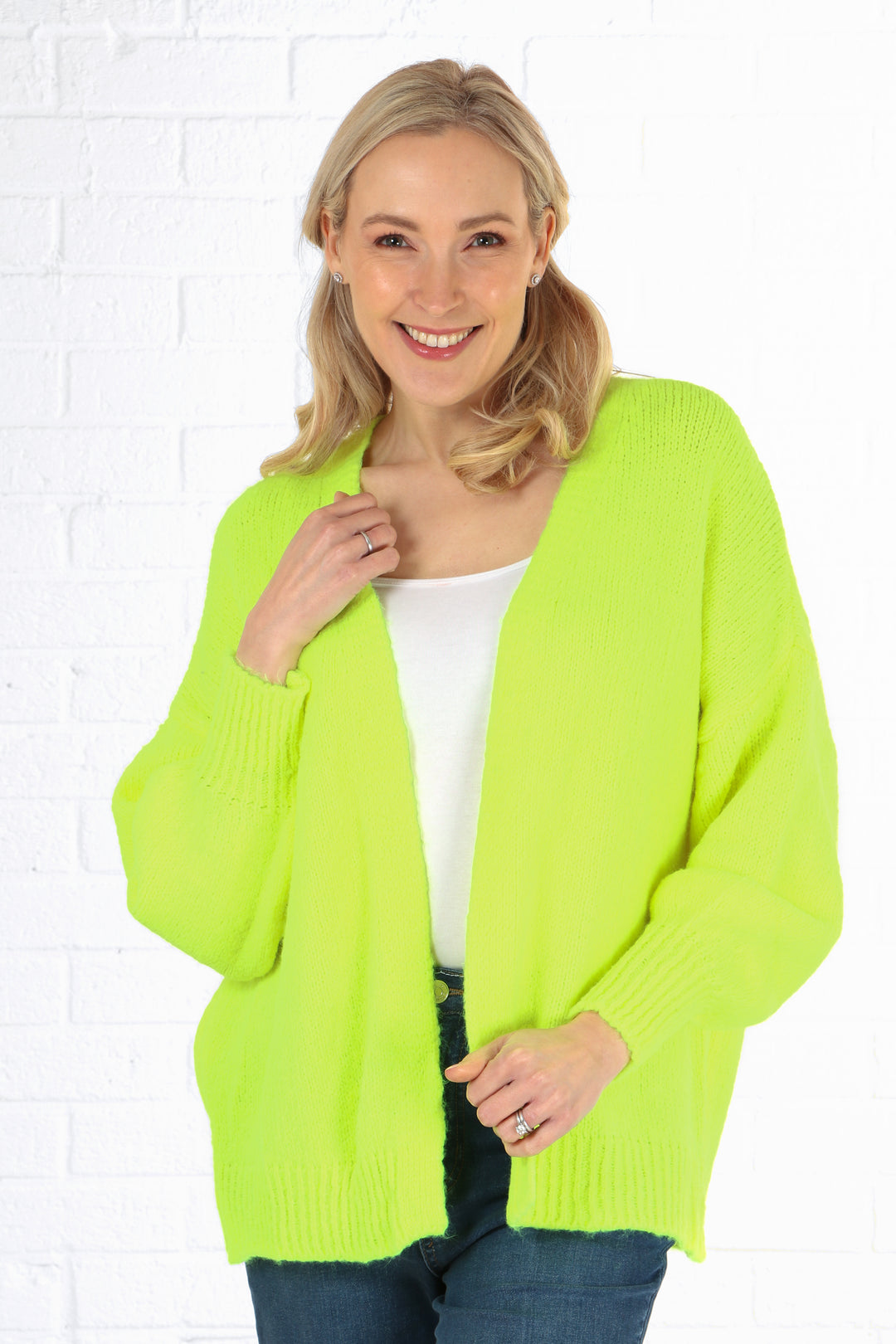 model wearing a neon yellow open front knitted cardigan with long sleeves
