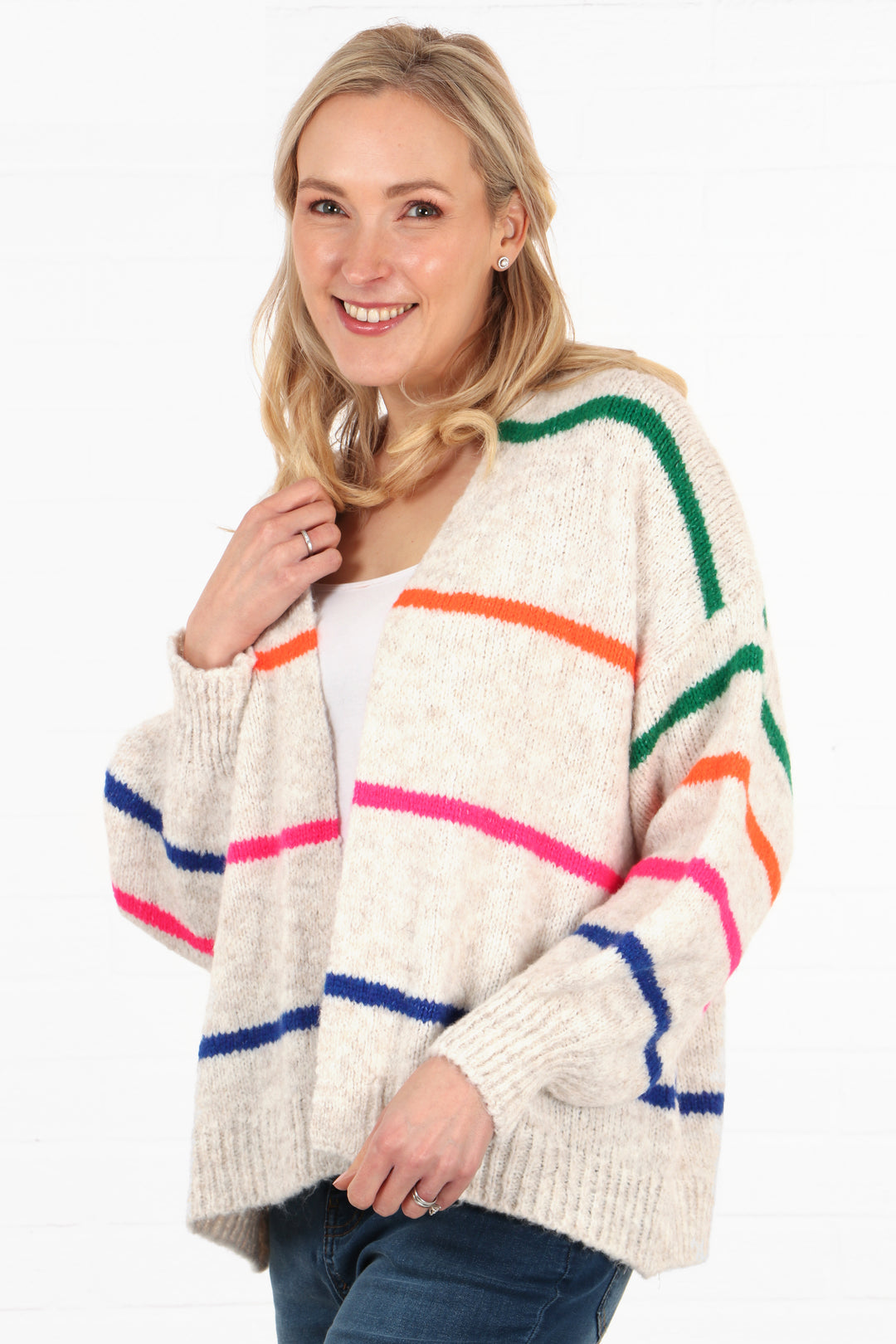 model showing a side view of the cream and multicoloured stripe cardigan, showing that the sleeves have stripes