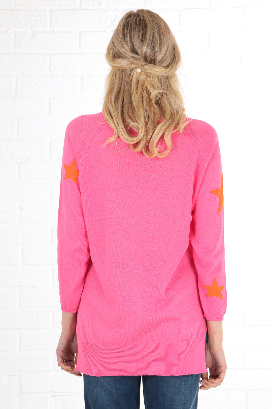 model showing the back of the jumper which has a plain pink back