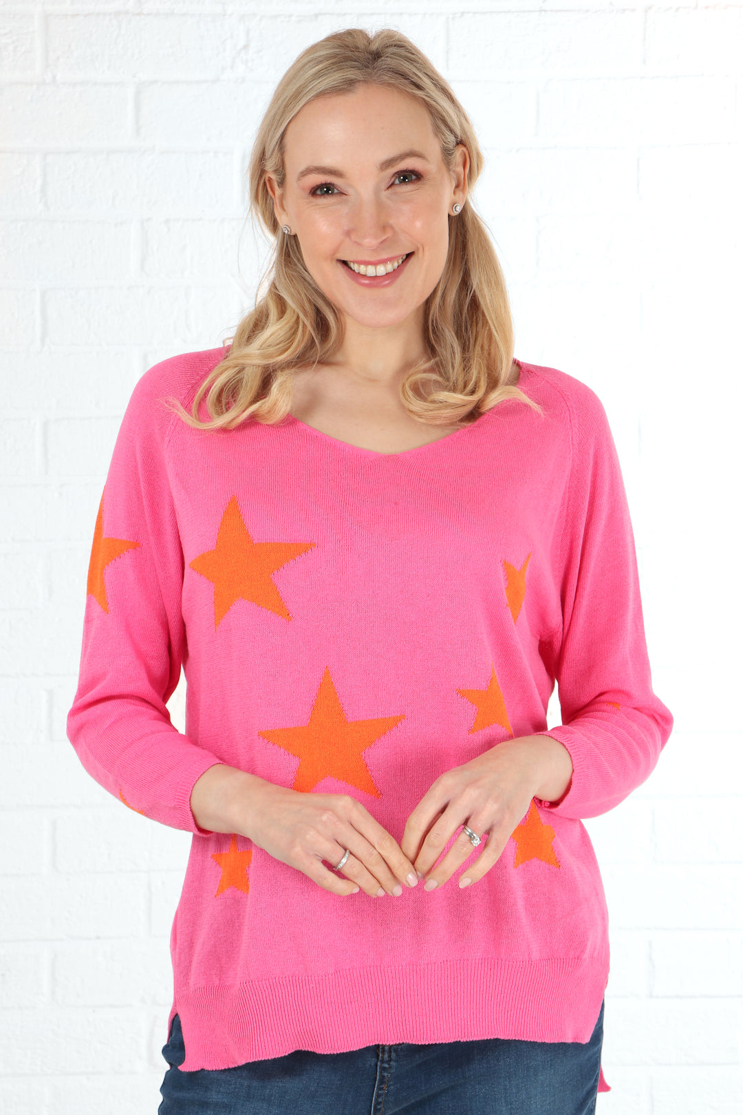 star print pink cotton jumper with a scattered orange star pattern