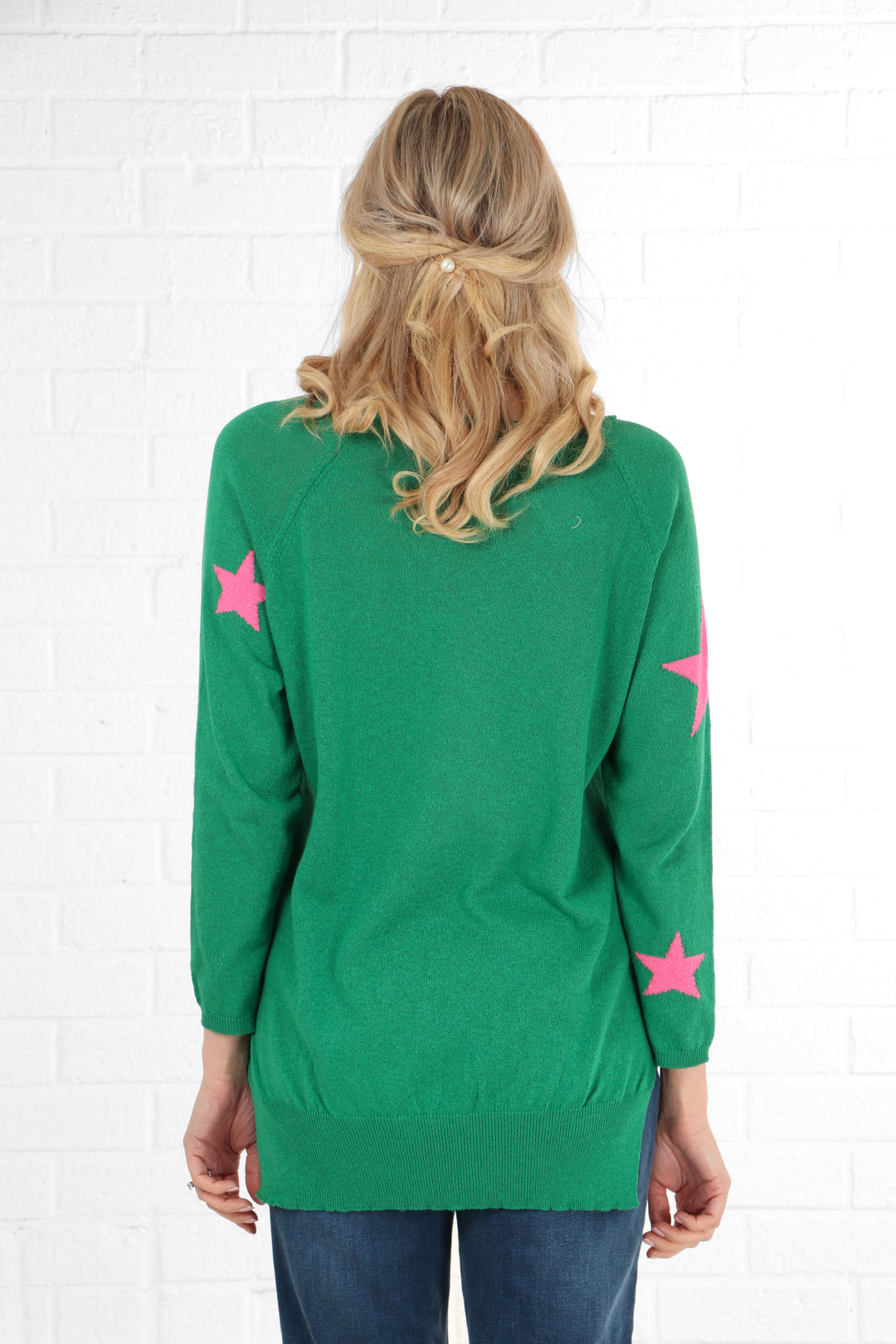 model showing the back of the jumper, showing that it is plain green