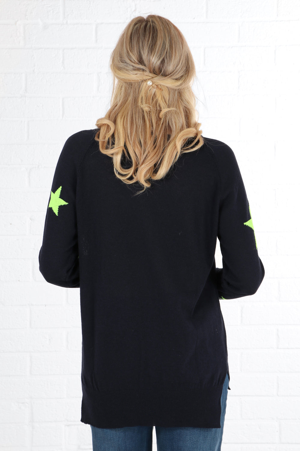 model showing the plain navy blue back of the jumper