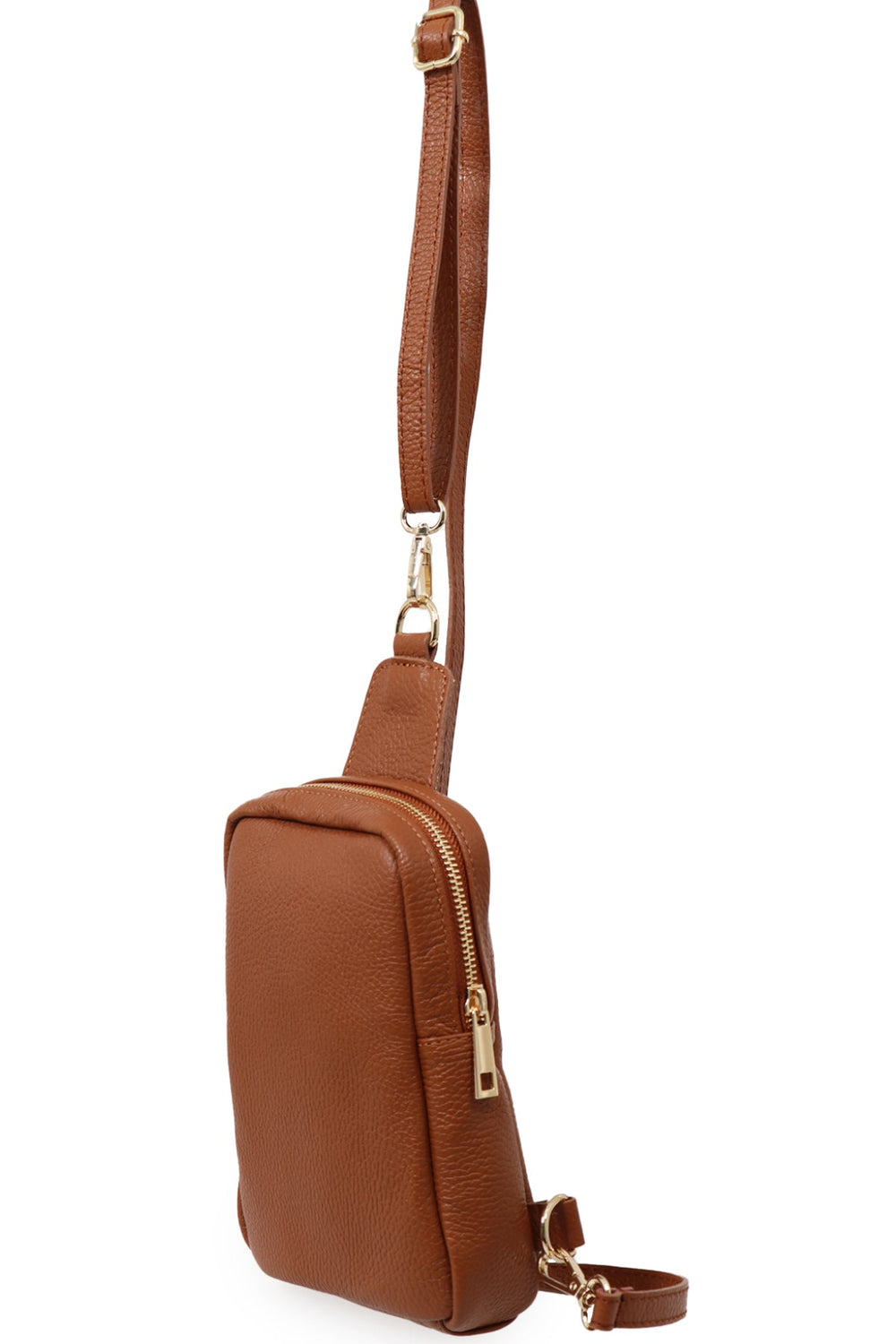 close up of the tan leather sling bag, showing the zip closure and gold hardware