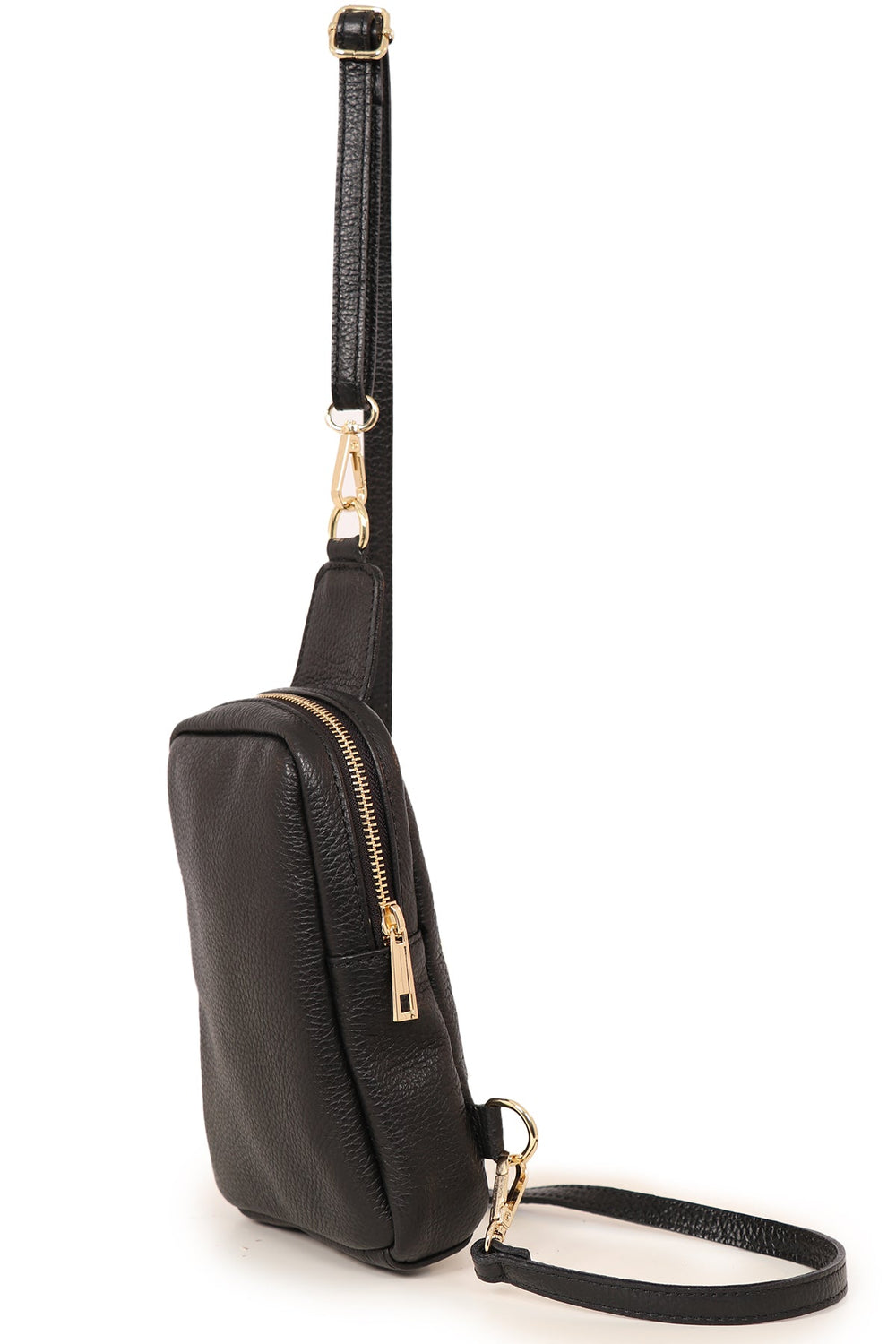 close up of the black leather sling bag, showing the zip closure and gold hardware