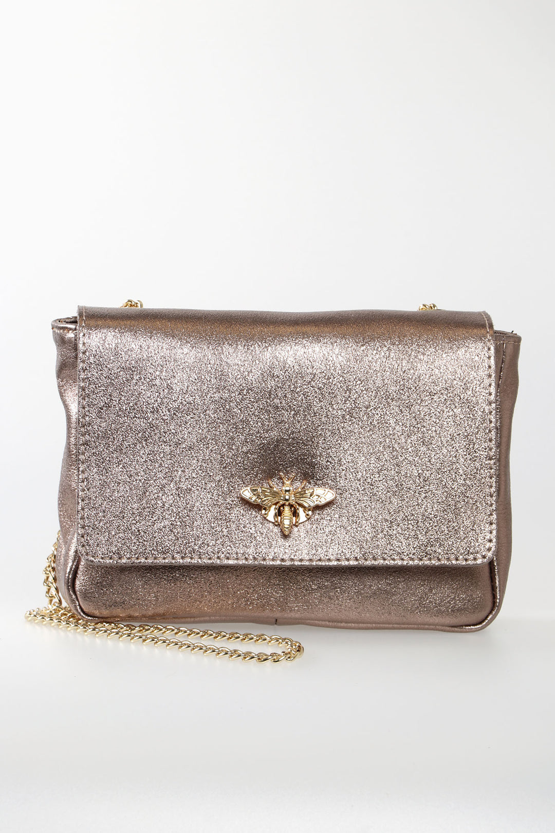 metallic rose gold pink leather crossbody bag with a prominent gold bee clasp on the front and a classic cuban link chain strap