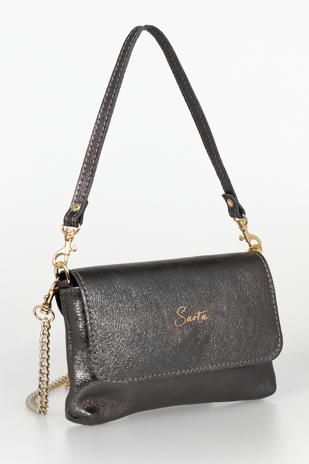 side view of the small cross body bag, showing the folding front closure, gold chain strap and detachable handle strap