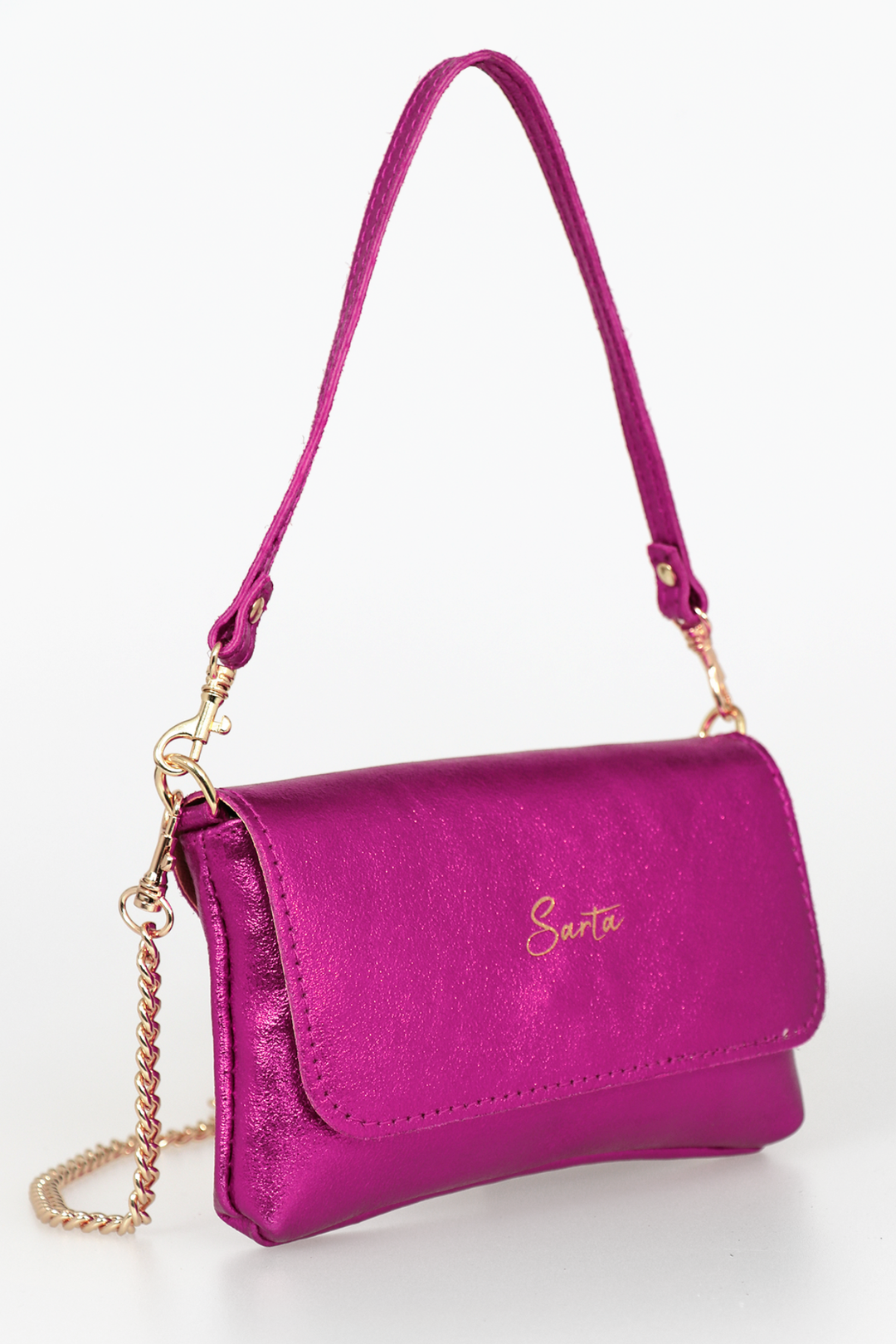 side view of the small cross body bag, showing the folding front closure, gold chain strap and detachable handle strap