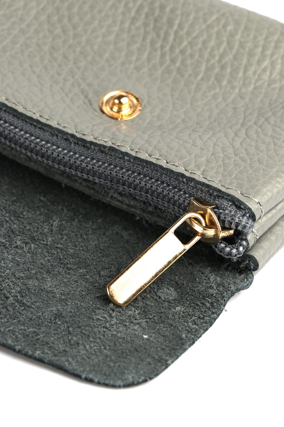 showing the zip closing internal compartment of the grey leather coin purse