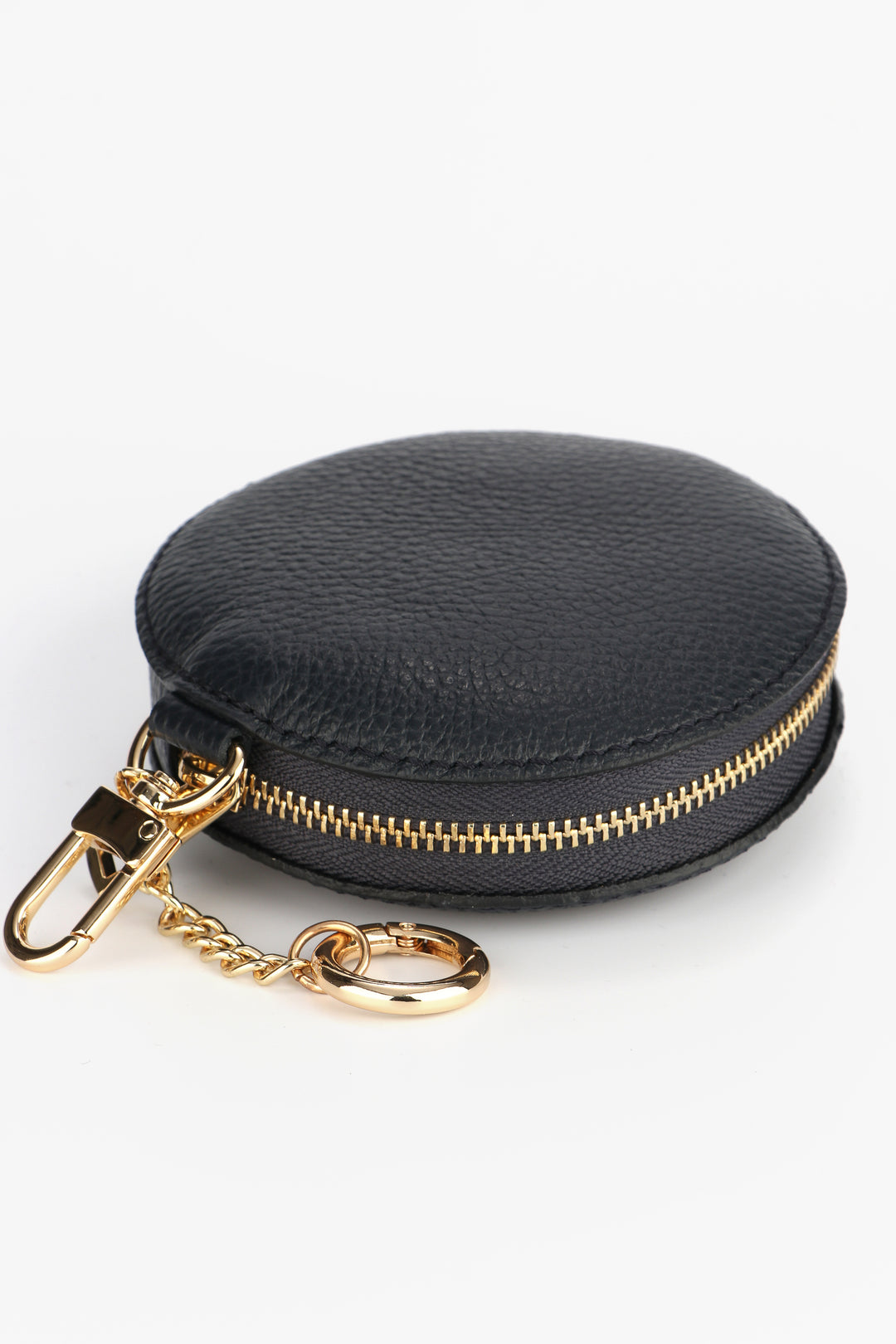 close up of the gold zip closure and clip on keyring attachments of the black leather coin purse