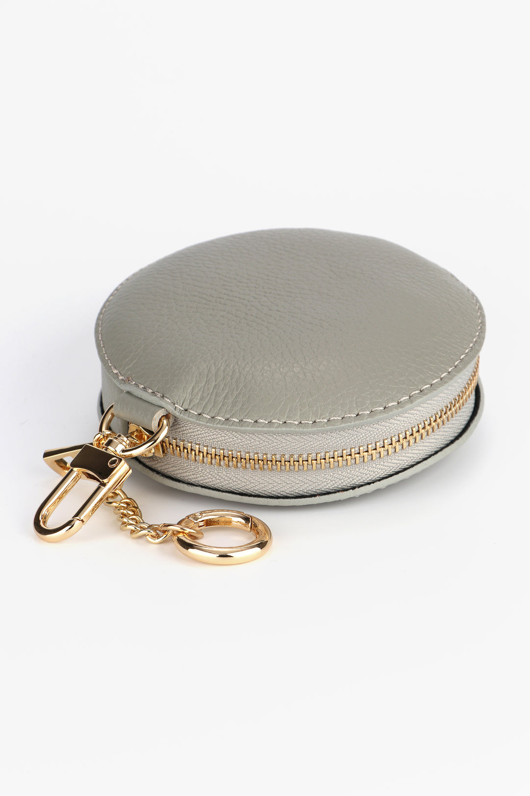 light grey round leather coin purse with a secure zip closure and gold hardware
