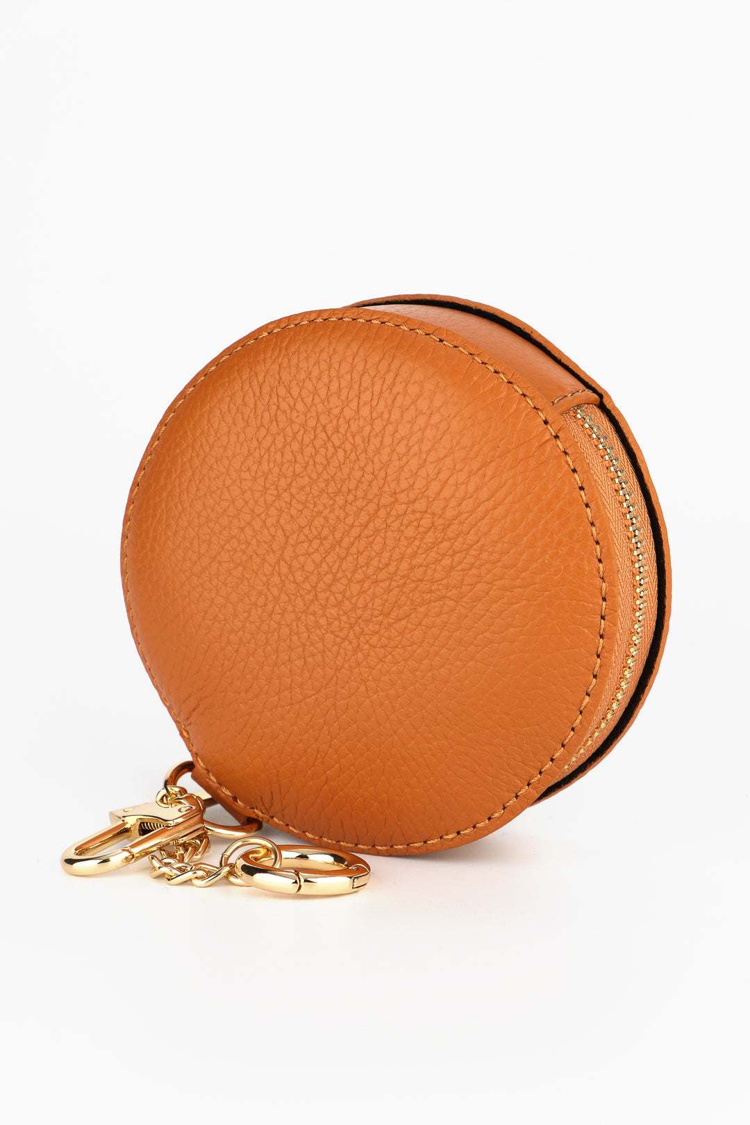 tan coloured round leather coin purse with a zip closure and two gold keyring attachments