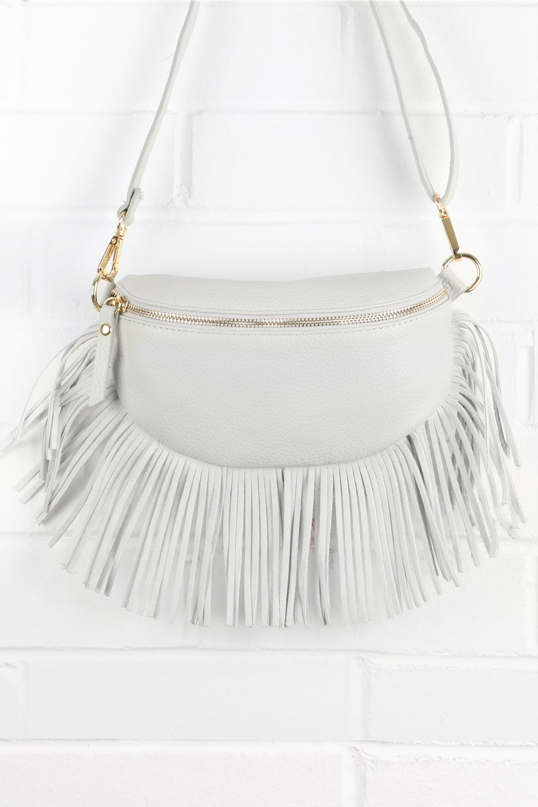 light grey leather halfmoon bag with fringed trim and zip closure