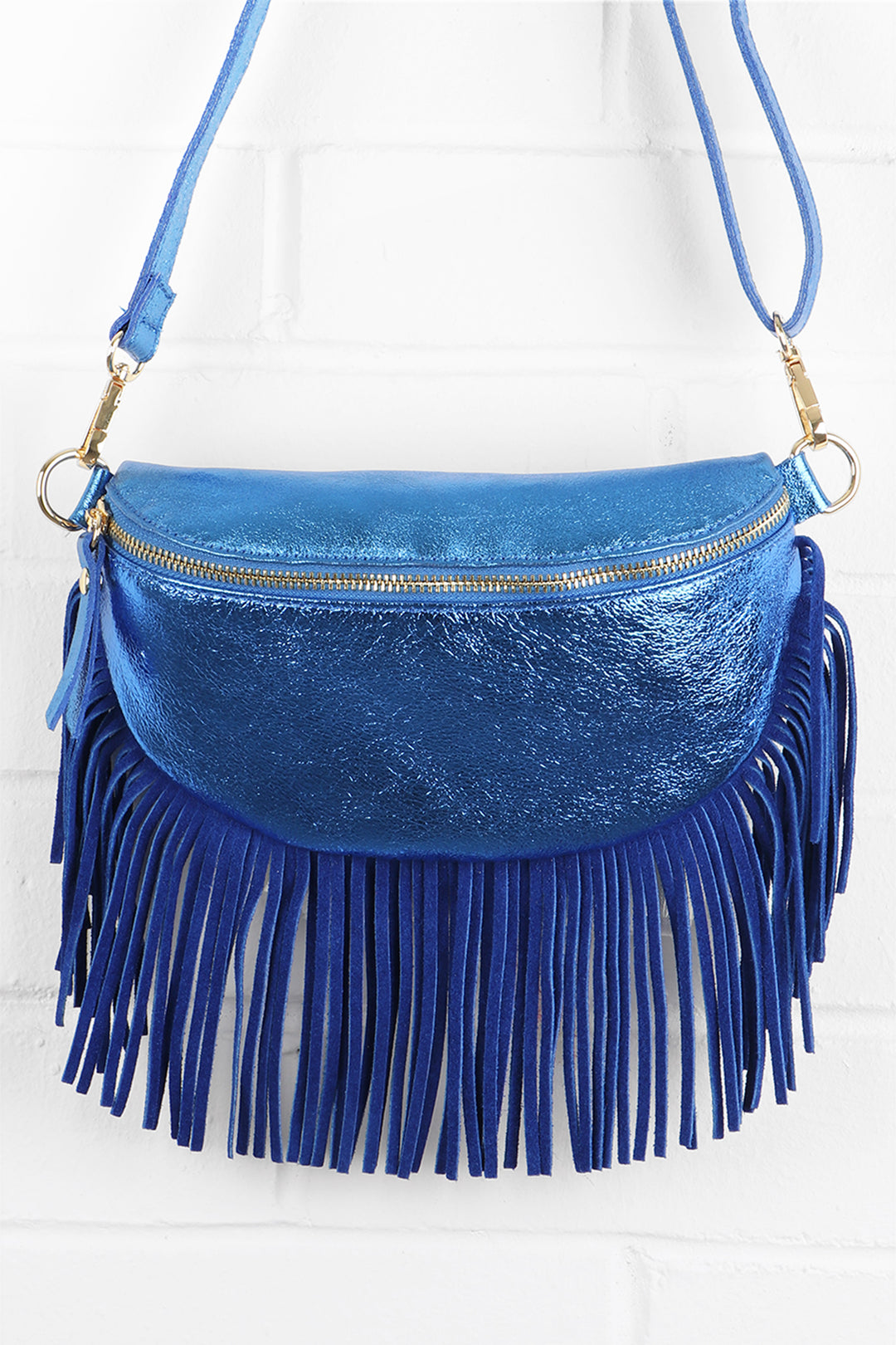 metallic blue leather halfmoon bag with fringed trim and zip closure