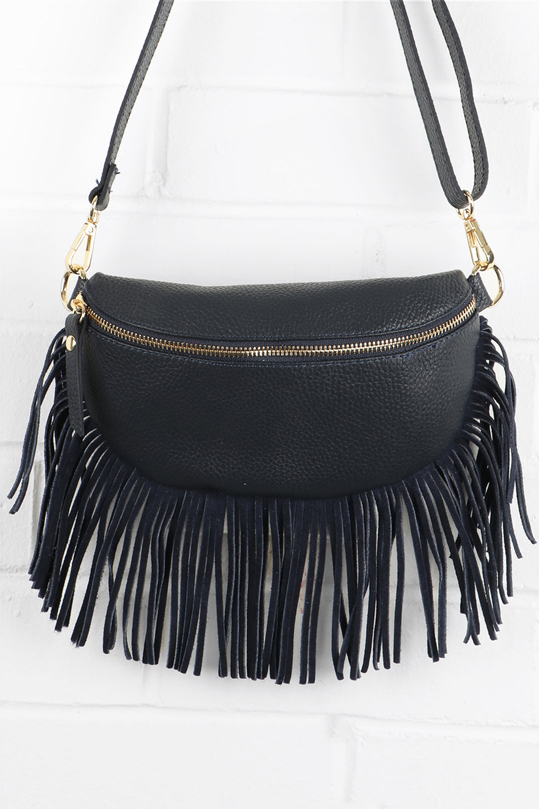 navy blue leather halfmoon bag with fringed trim and zip closure