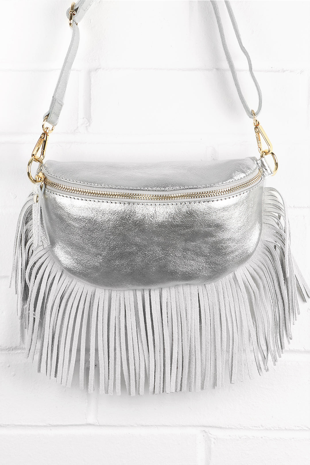 silver leather halfmoon bag with fringed trim and zip closure