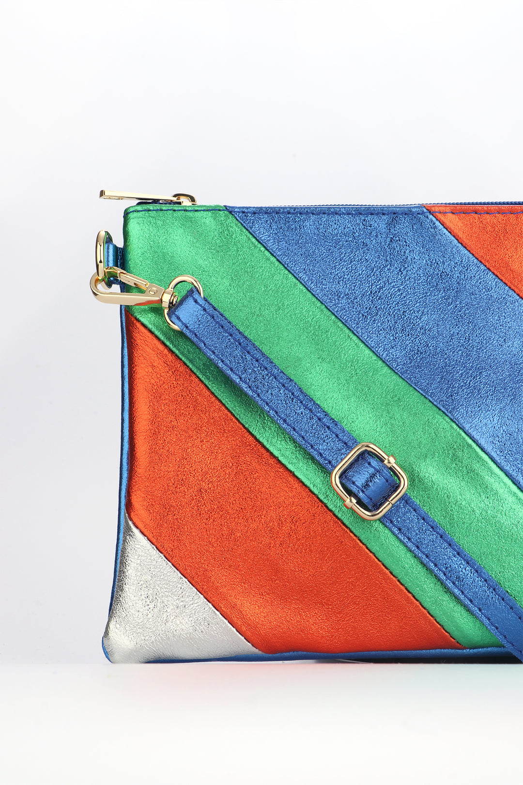 close up of the striped leather clutch bag showing the blue crossbody strap