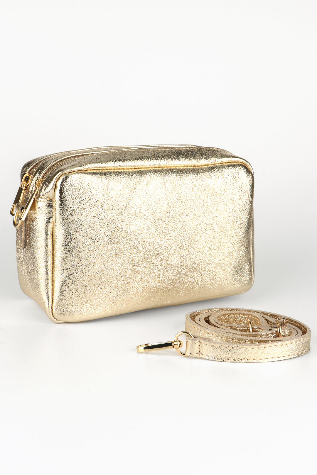 gold leather cross body camera bag with a matching detachable bag strap and two zip closing compartments