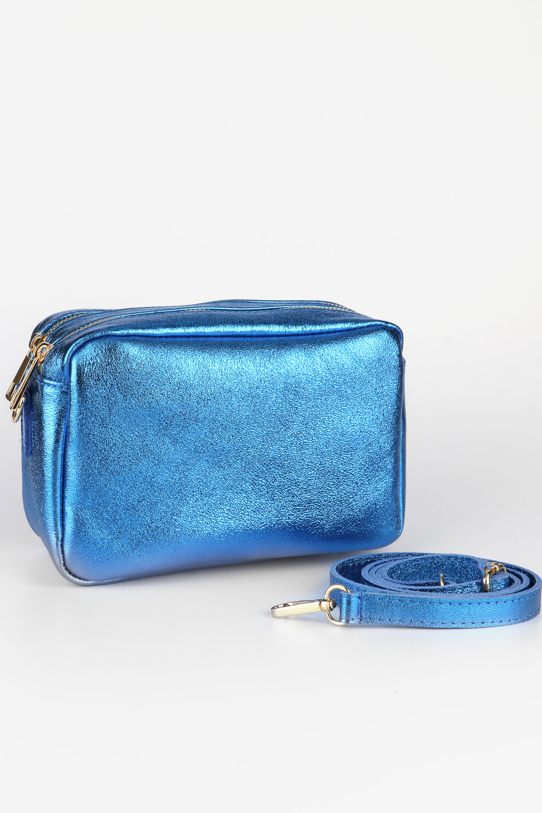 metallic blue leather cross body camera bag with dual zip closure compartments and a detachable matching clip on bag strap