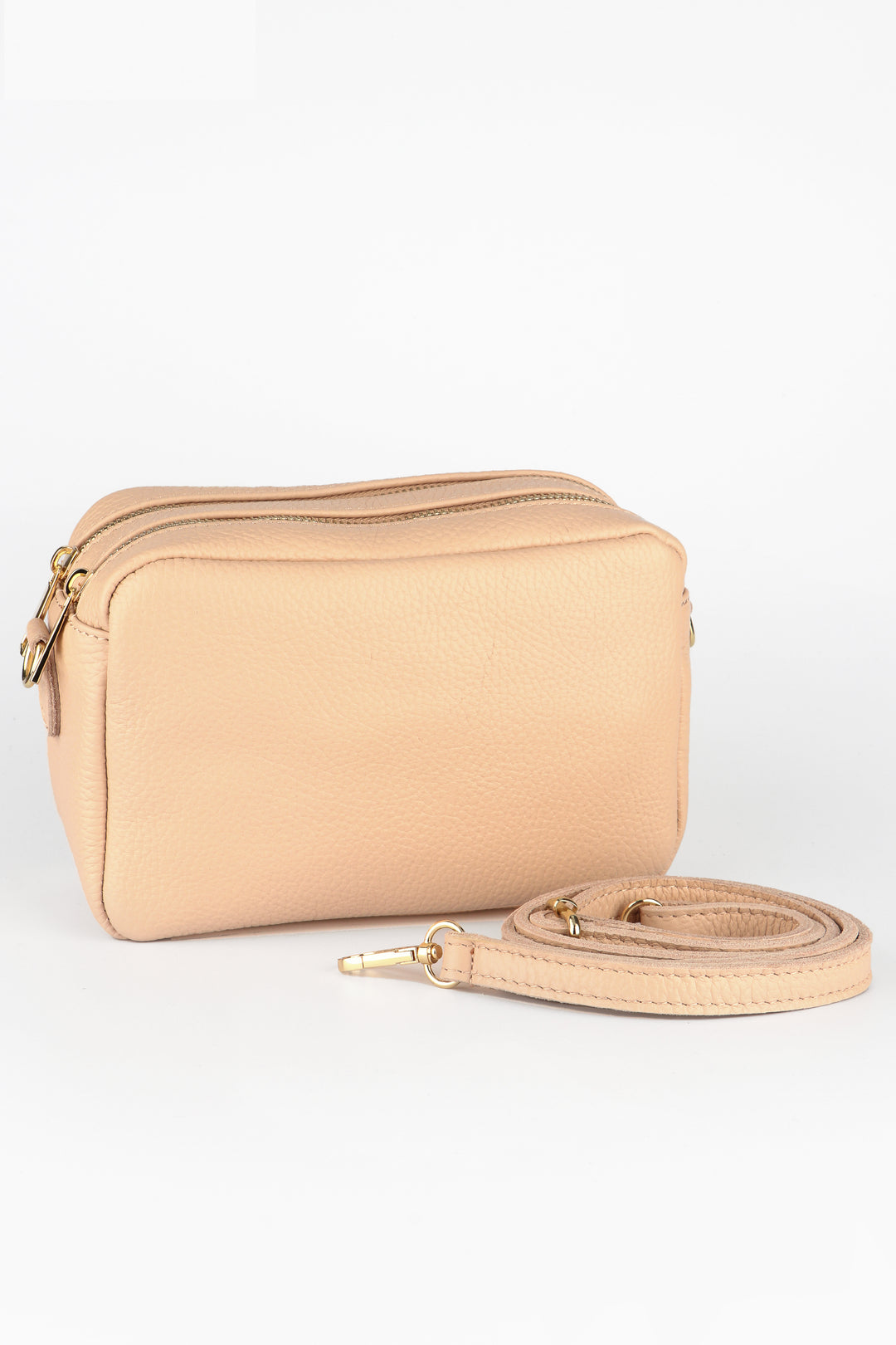 nude beige italian leather cross body camera bag with two zip closure compartments and a detachable matching bag strap