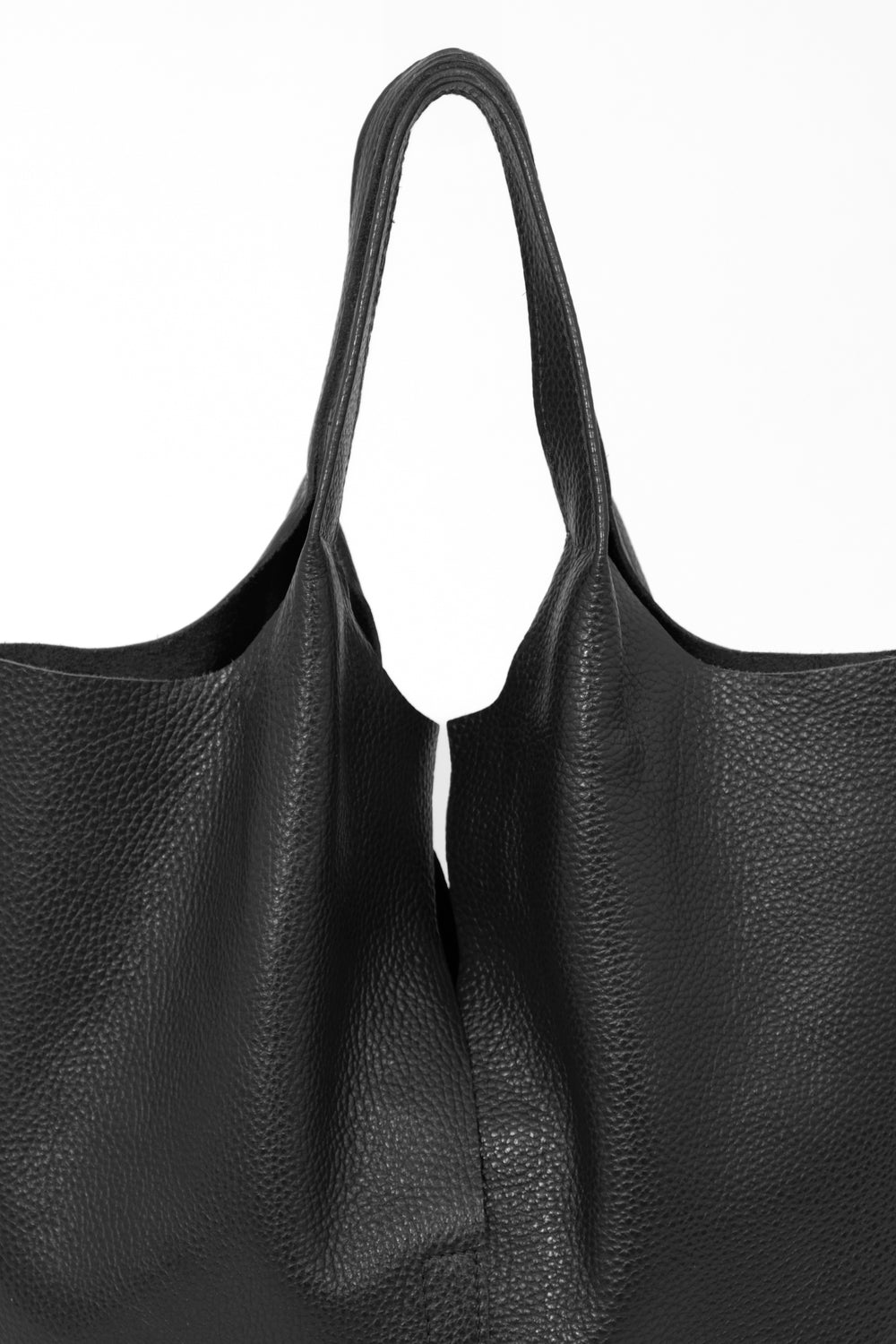 close up of the black pebbled leather and top carry handles on the tote bag