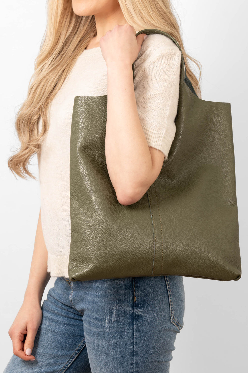 close up of the khaki green pebbled leather and top carry handles on the tote bag